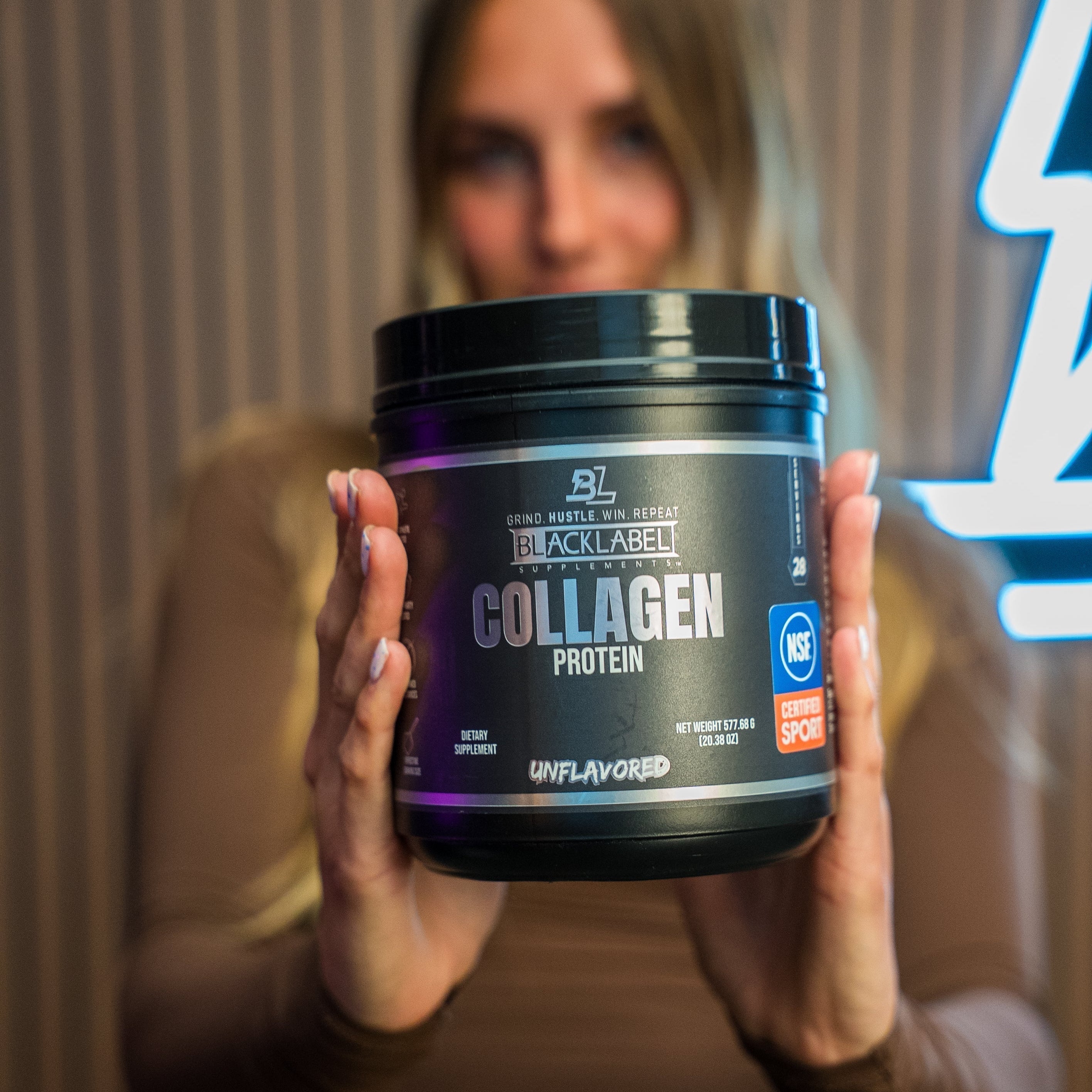 COLLAGEN PROTEIN supplement in a black tub with a dark label, blue accents, and an unflavored designation