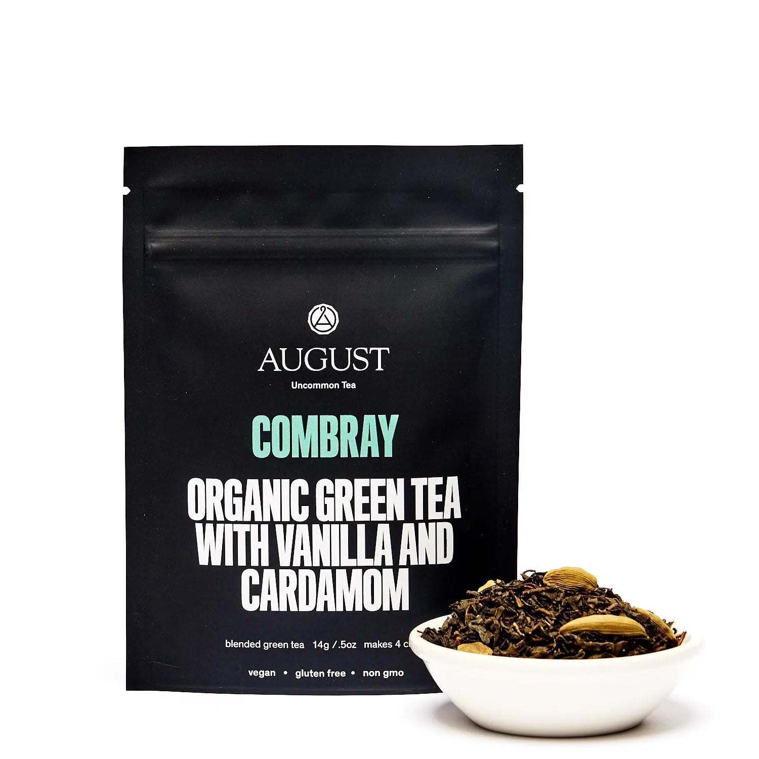 Combray - Vanilla Cardamom Green Tea in a black pouch with a white bowl of loose leaf tea and cardamom pods