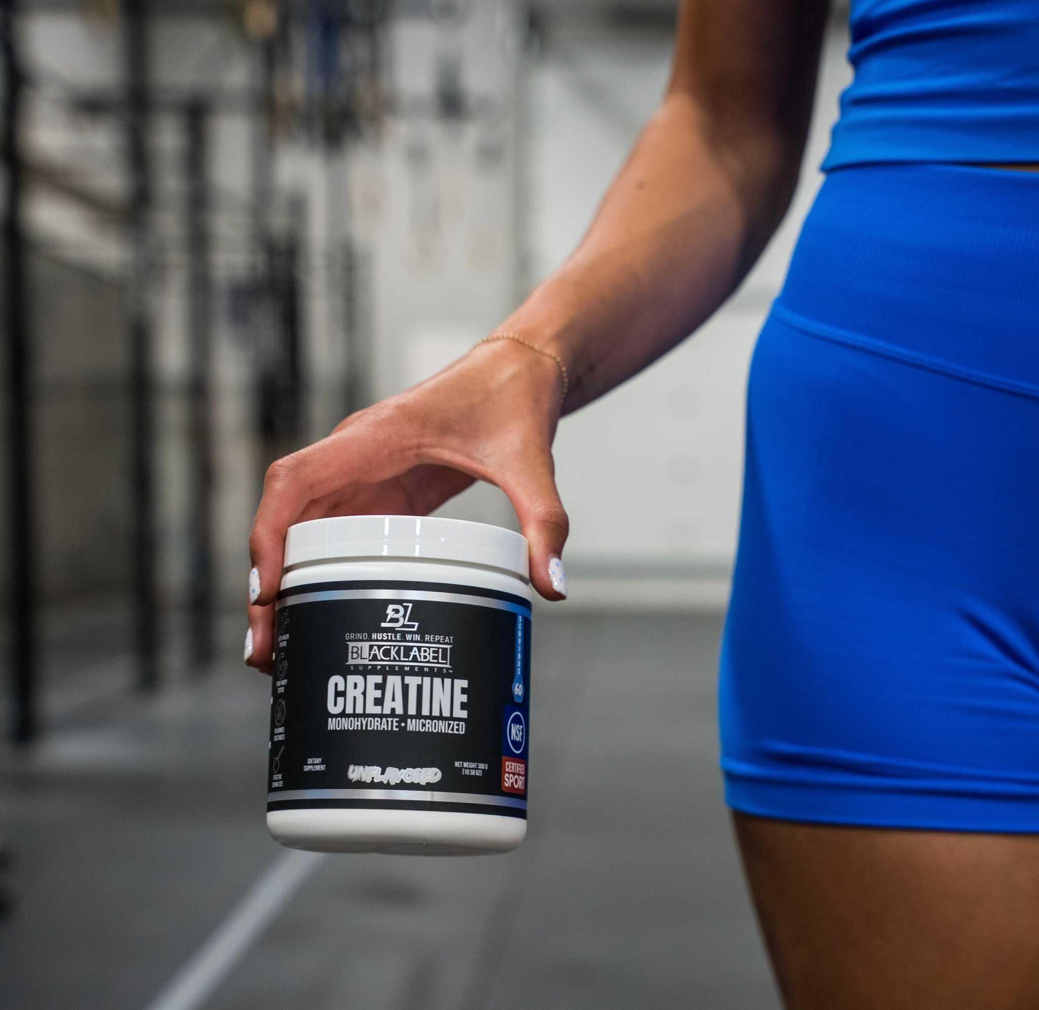 CREATINE MONOHYDRATE supplement in a black and white plastic tub with a white lid and bold label