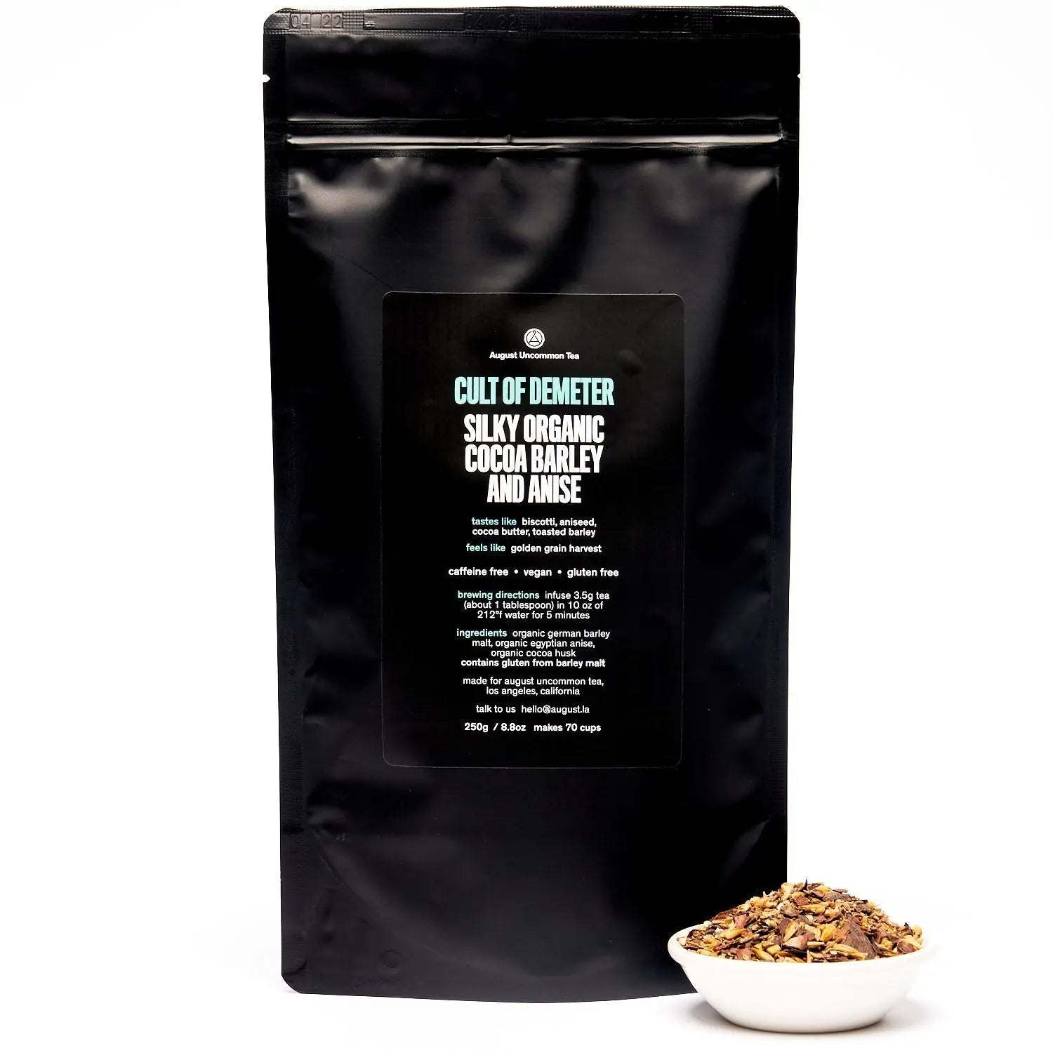 Cult of Demeter - Tea black pouch with cocoa barley and anise loose tea blend in a white bowl