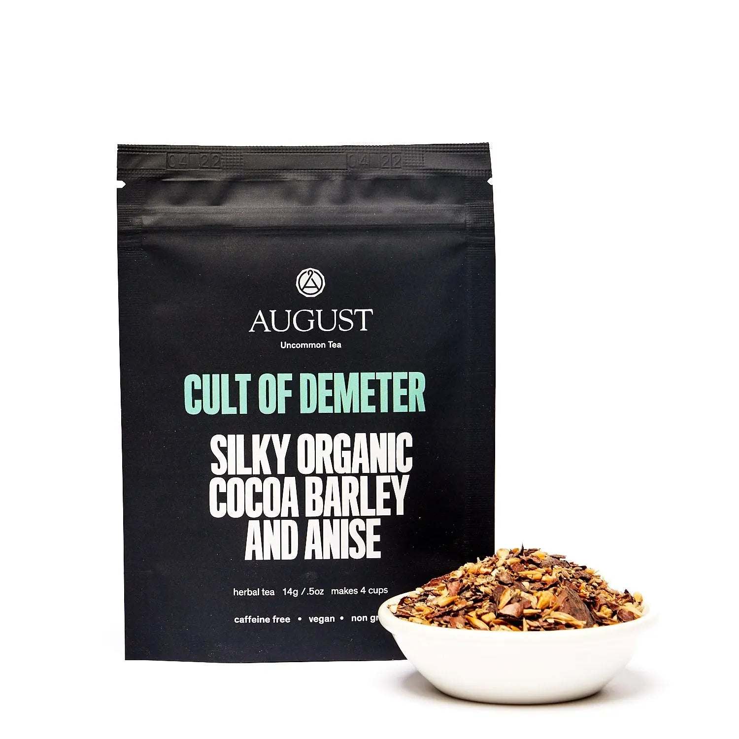 Cult of Demeter - Tea loose herbal blend in black packaging, with visible cocoa, barley and anise pieces in a bowl