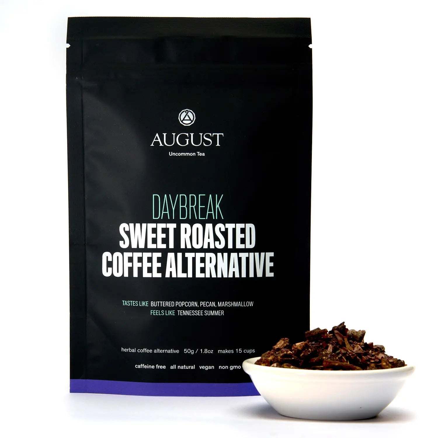 Daybreak - Sweet Roasted Coffee Alternative in a black tea pouch with a purple base, beside loose roasted herbal blend