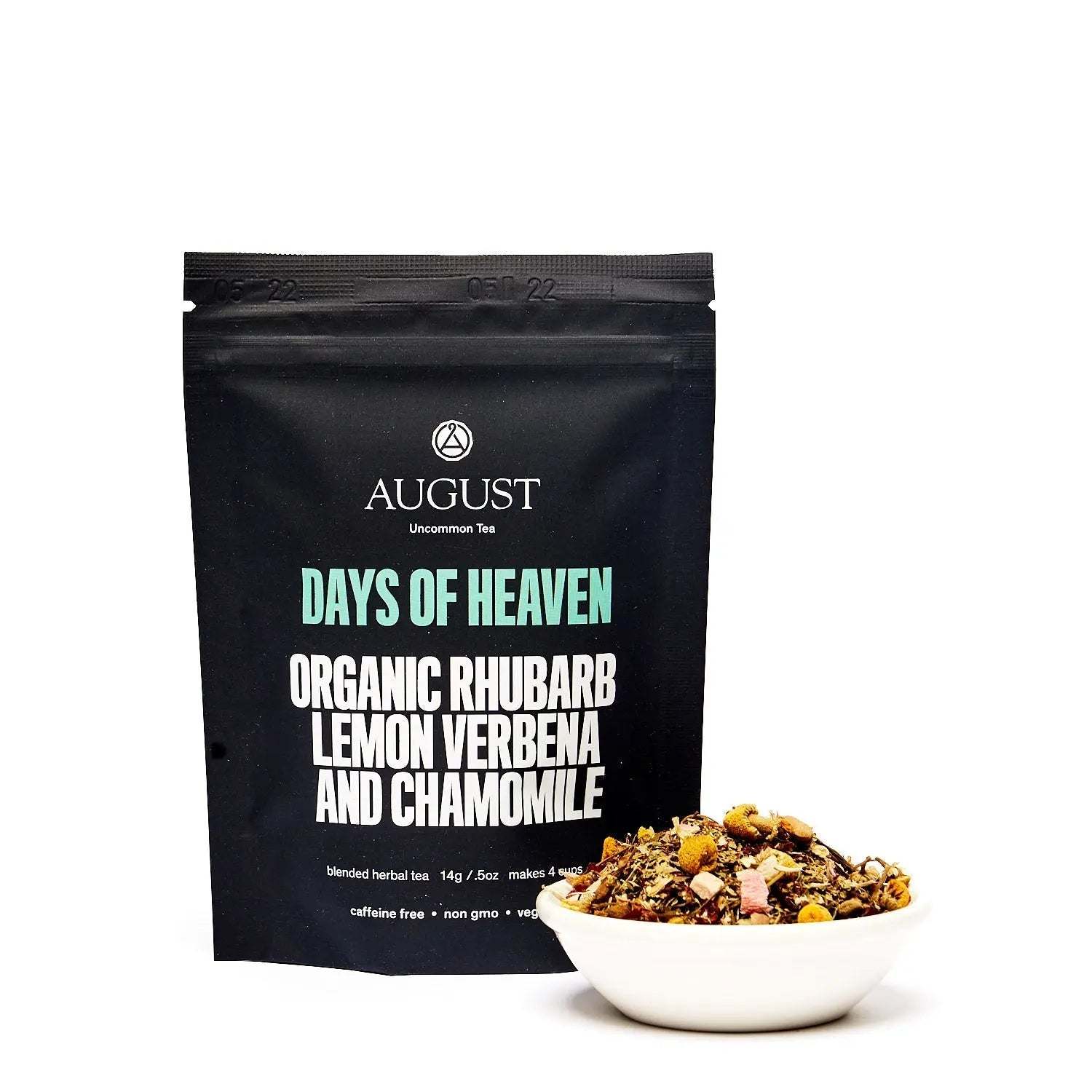 Days of Heaven tea in a black pouch with a bowl of loose organic rhubarb, lemon verbena and chamomile herbal blend