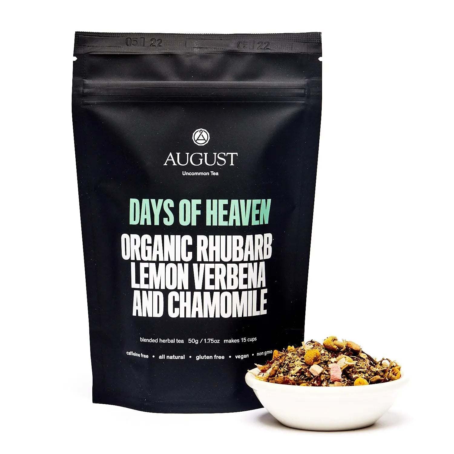 Days of Heaven tea in a black resealable pouch with organic rhubarb, lemon verbena and chamomile, beside loose herbal tea