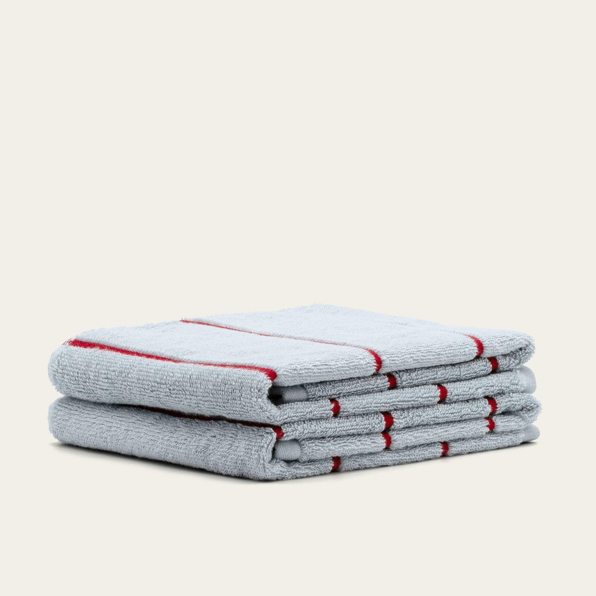 Deia Australian Cotton towels in light gray, with plush cotton texture and narrow red stripe detailing