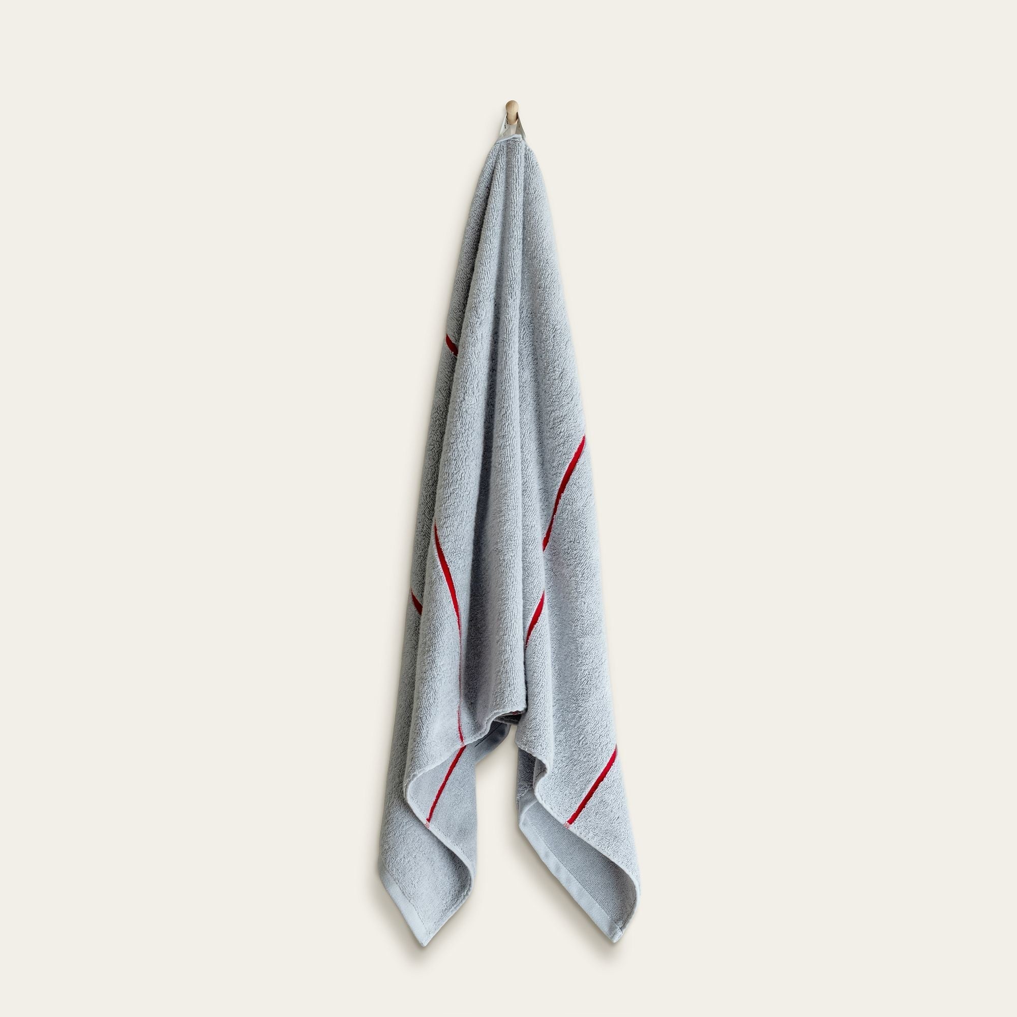 Deia Australian Cotton towel in pale blue with a plush terry texture and thin red accent stripes