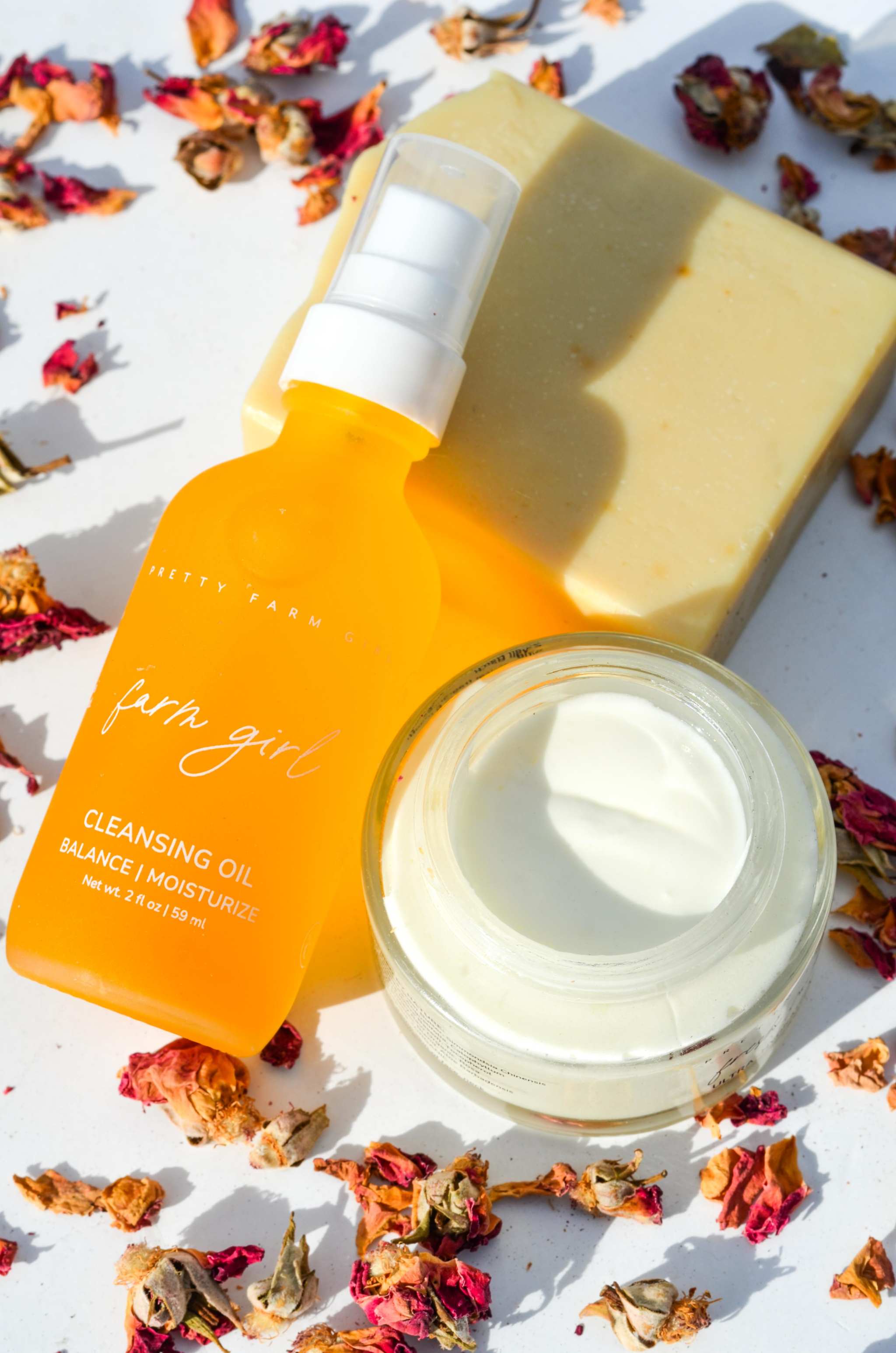 Double Cleansing Anti Aging Kit with orange cleansing oil, cream soap bar, and white face cream