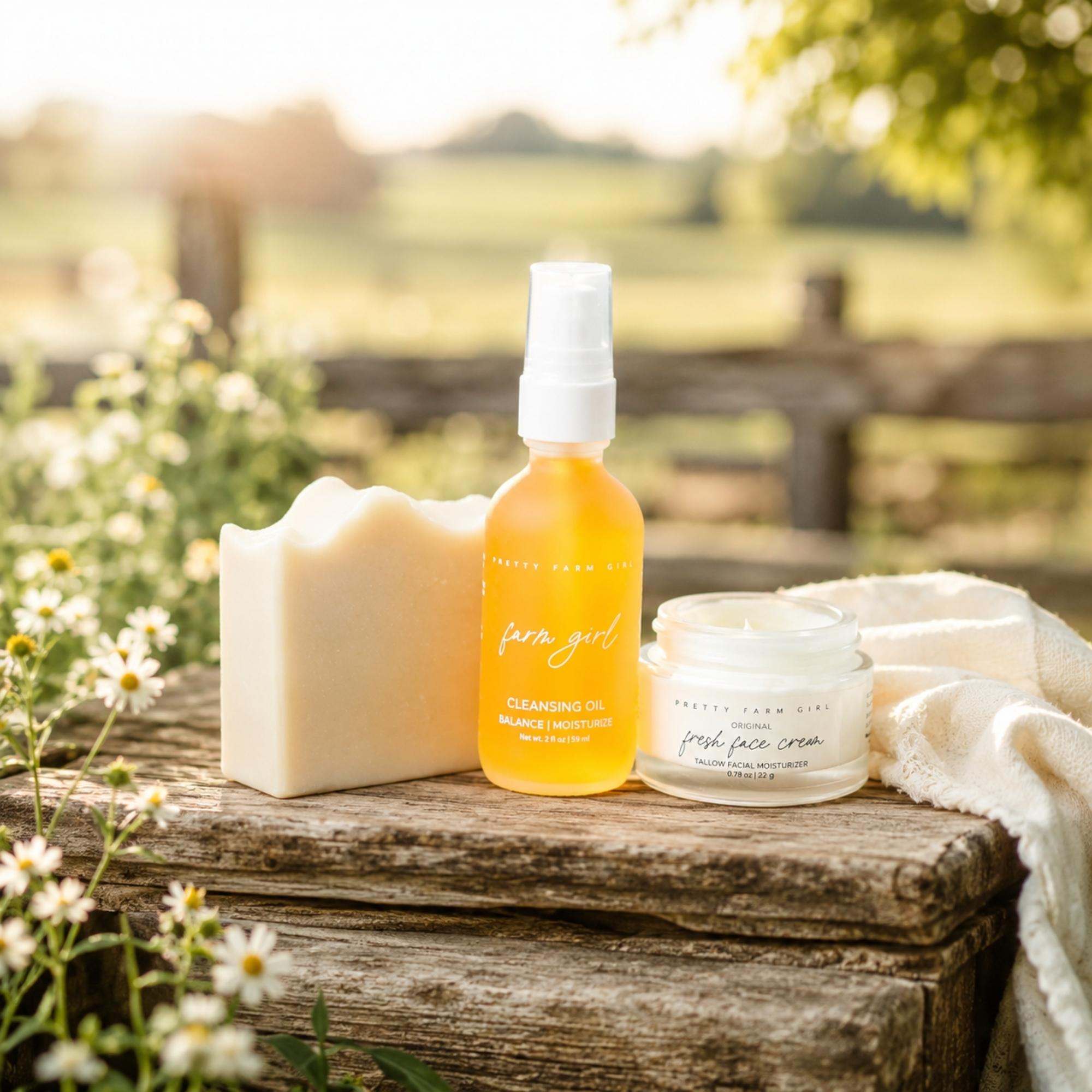 Double Cleansing Anti Aging Kit with cream soap bar, amber cleansing oil bottle, white face cream jar, and towel