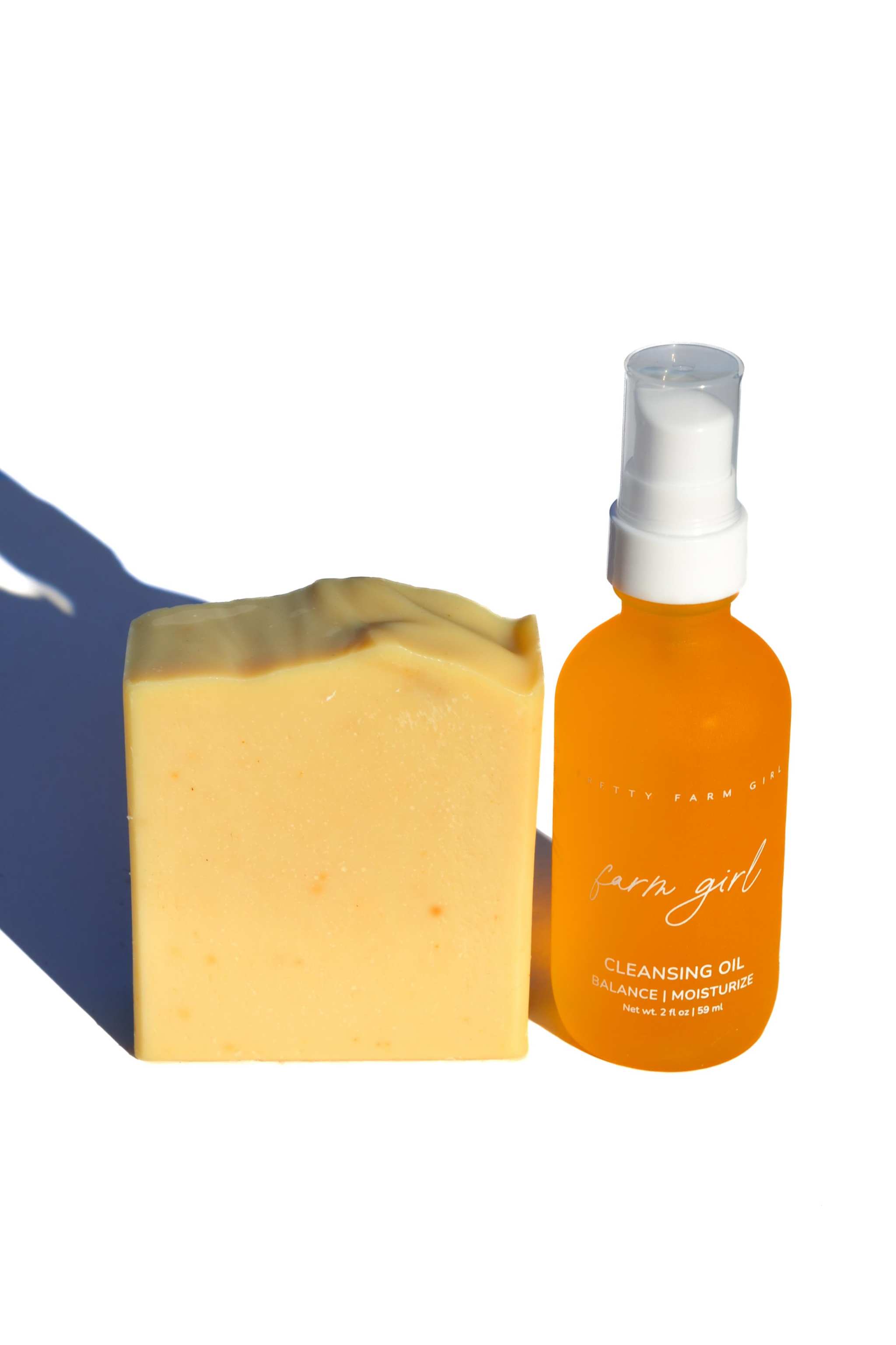 Double Cleansing Anti Aging Kit with yellow cream soap bar and amber cleansing oil pump bottle