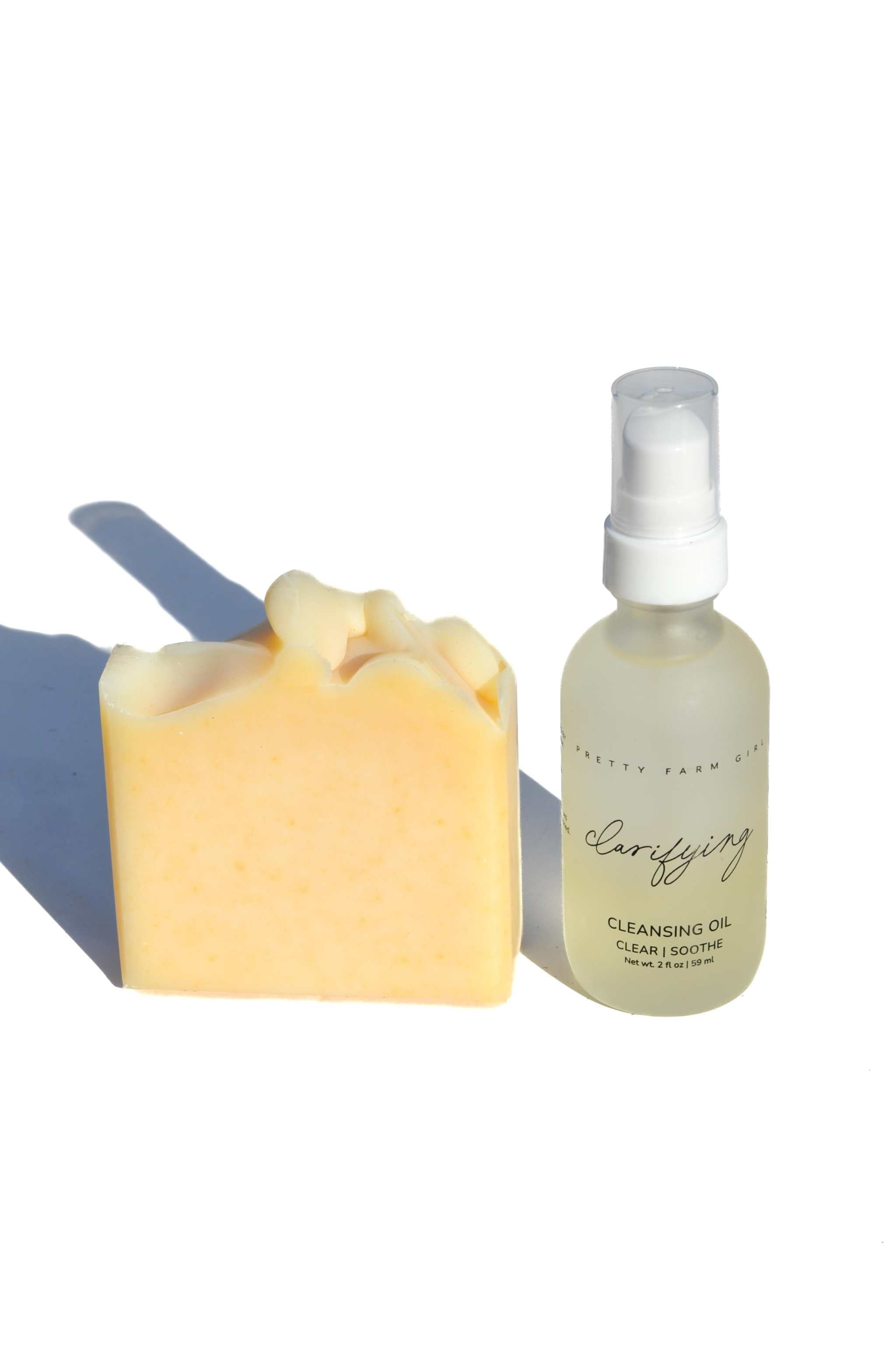 Double Cleansing Kit Soothing with yellow handmade soap bar and clear cleansing oil glass pump bottle

