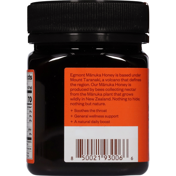 Egmont Manuka Honey in a dark jar with a black ribbed lid and orange label featuring product details and barcode