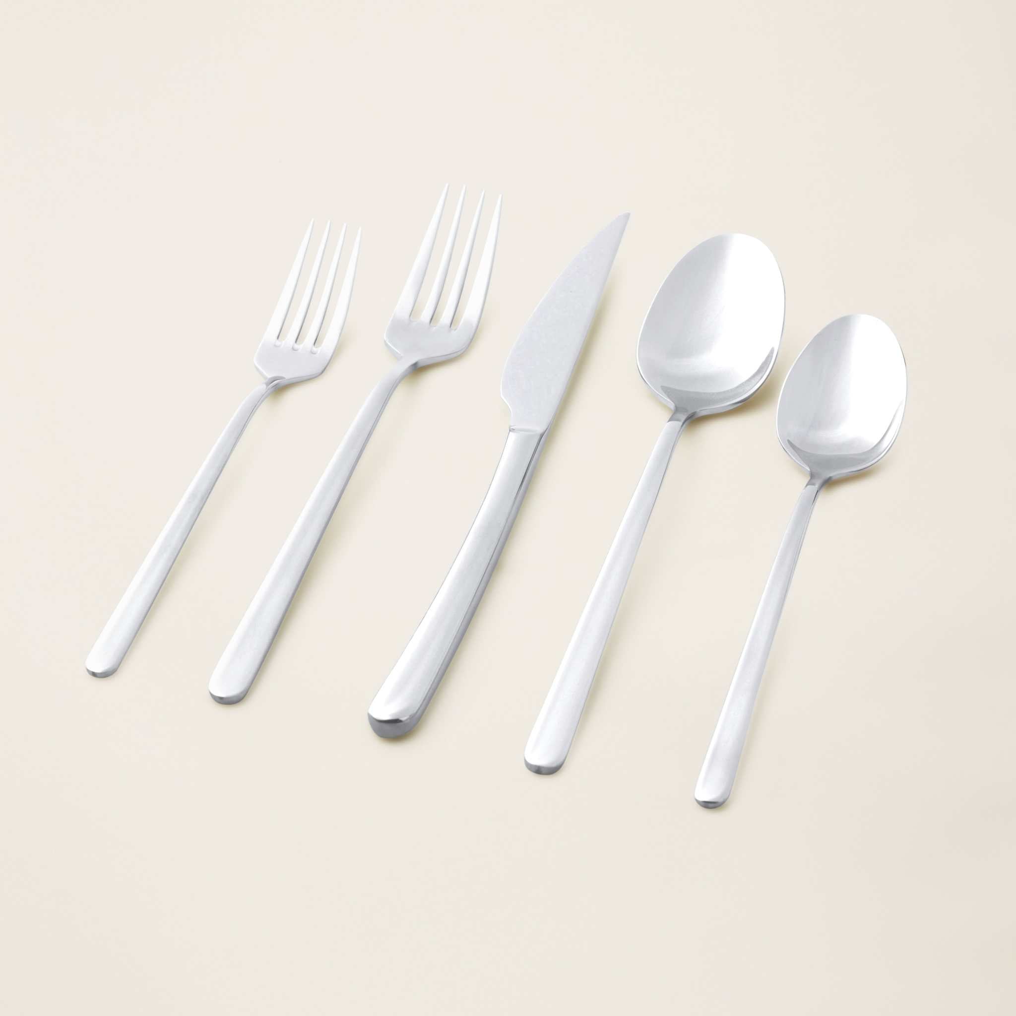 Emilia Mirror 20-Piece Flatware Set in polished silver stainless steel, with contemporary knives, forks, and spoons