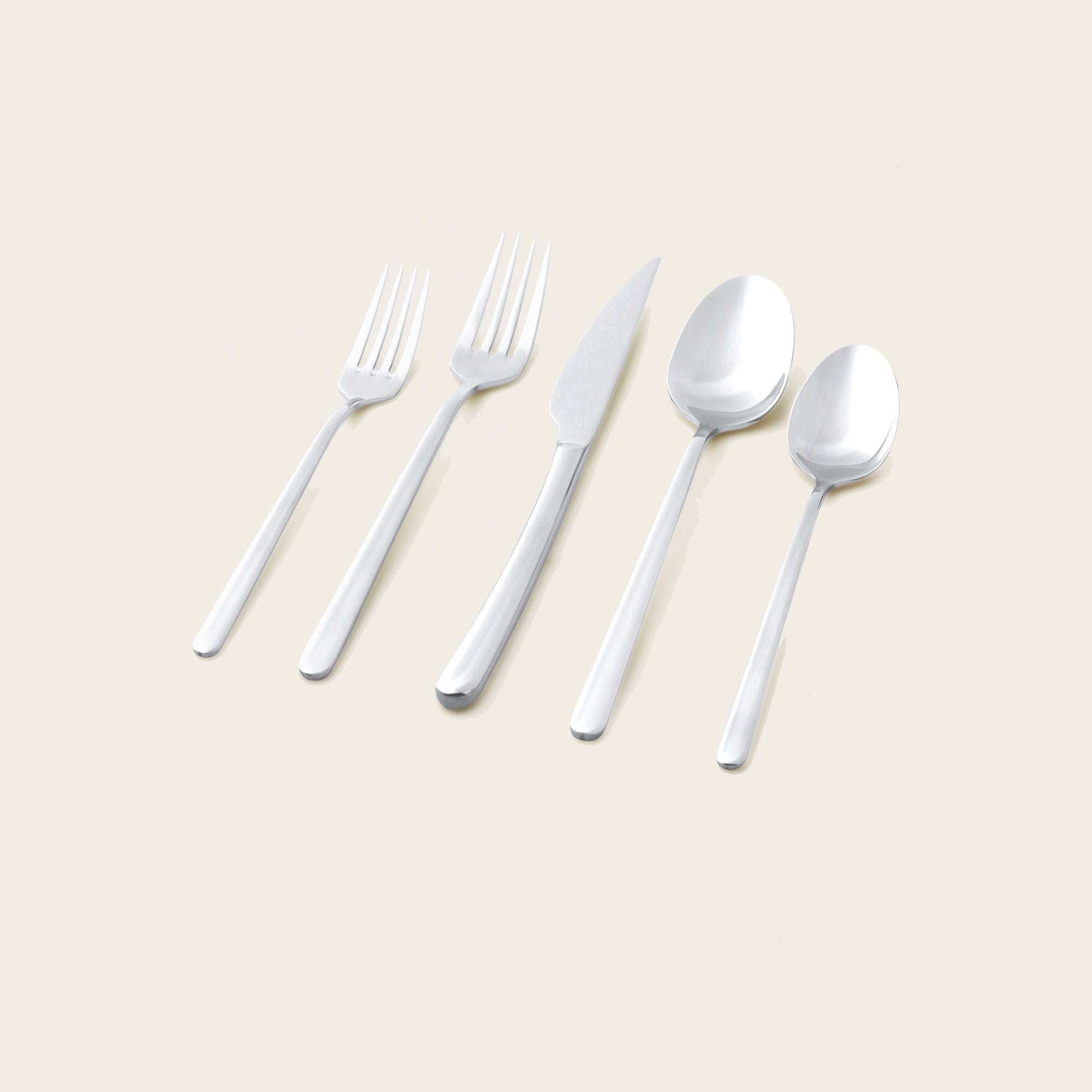 Emilia Mirror 20-Piece Flatware Set with polished silver stainless steel fork, knife and spoons in sleek contemporary shapes