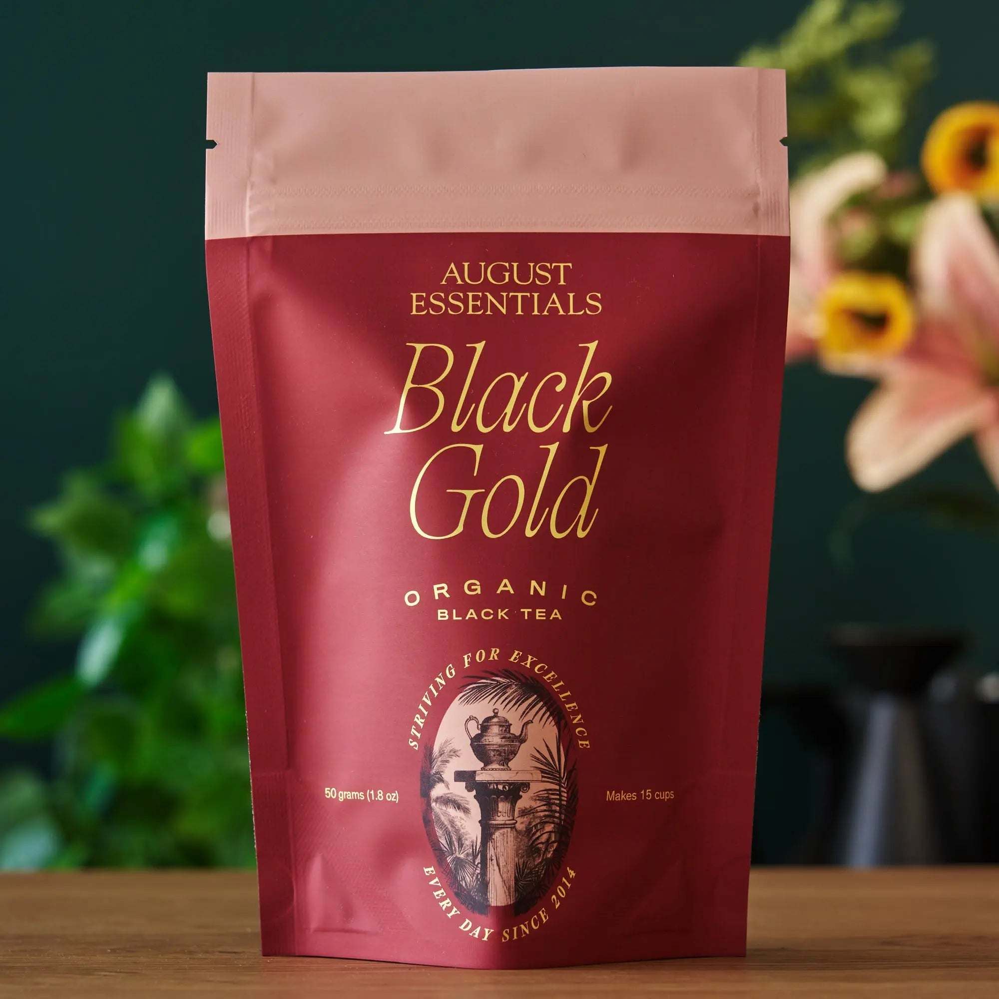 Essentials Black Gold Tea organic black tea in a red resealable pouch with gold lettering and vintage emblem