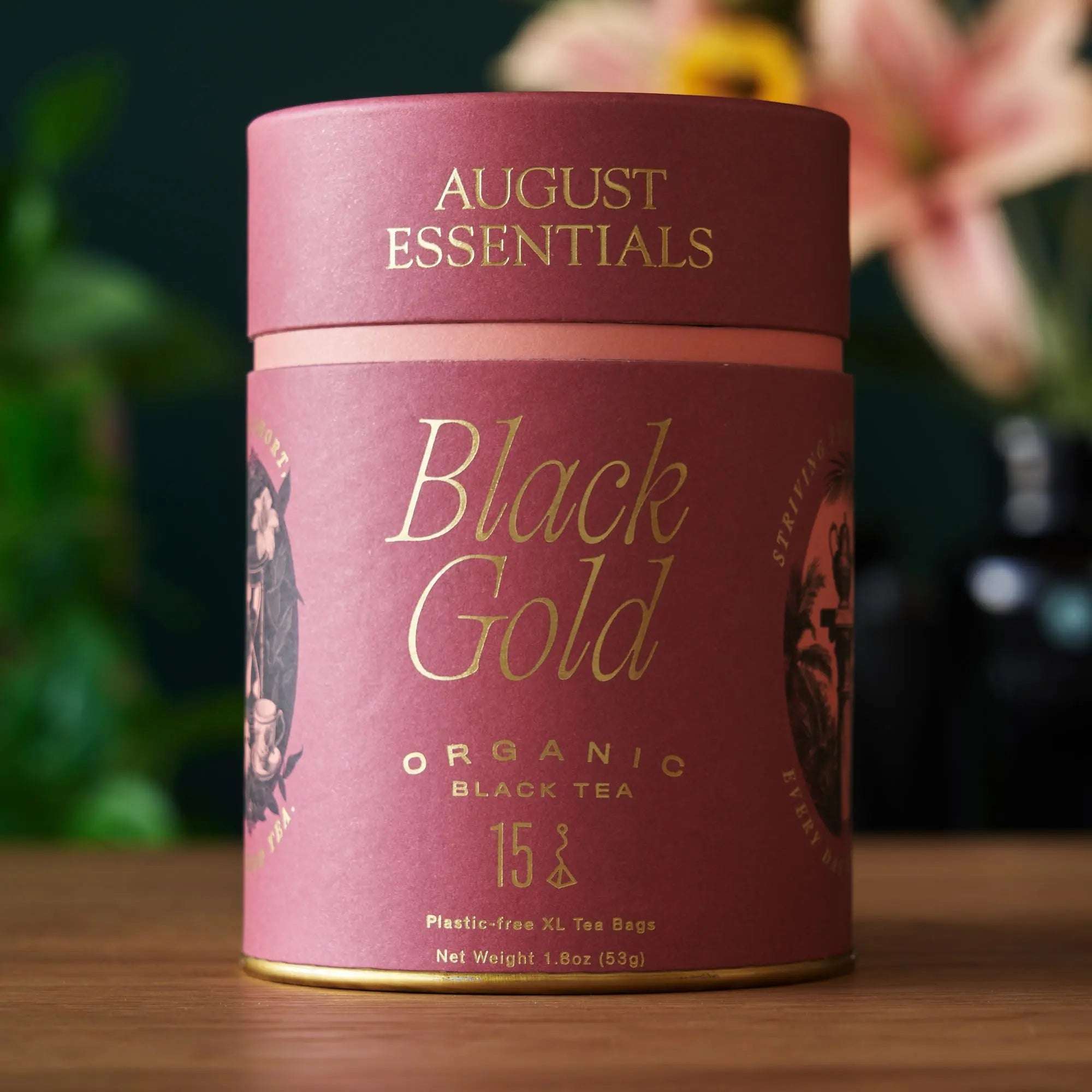 Essentials Black Tea tin in burgundy and pink, with gold lettering and botanical illustrations, 15 tea bags