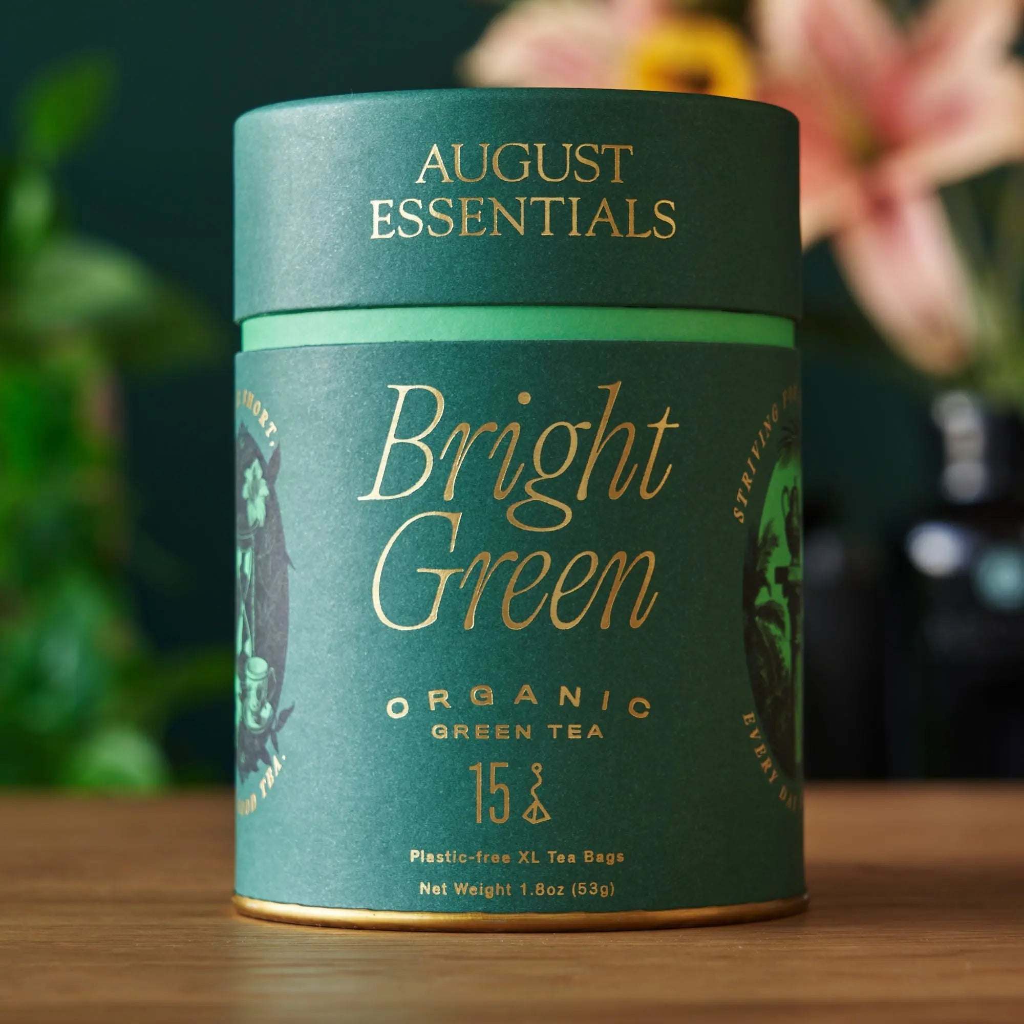 Essentials Bright Green Tea in a dark green organic tea tin with gold lettering and 15 tea bags