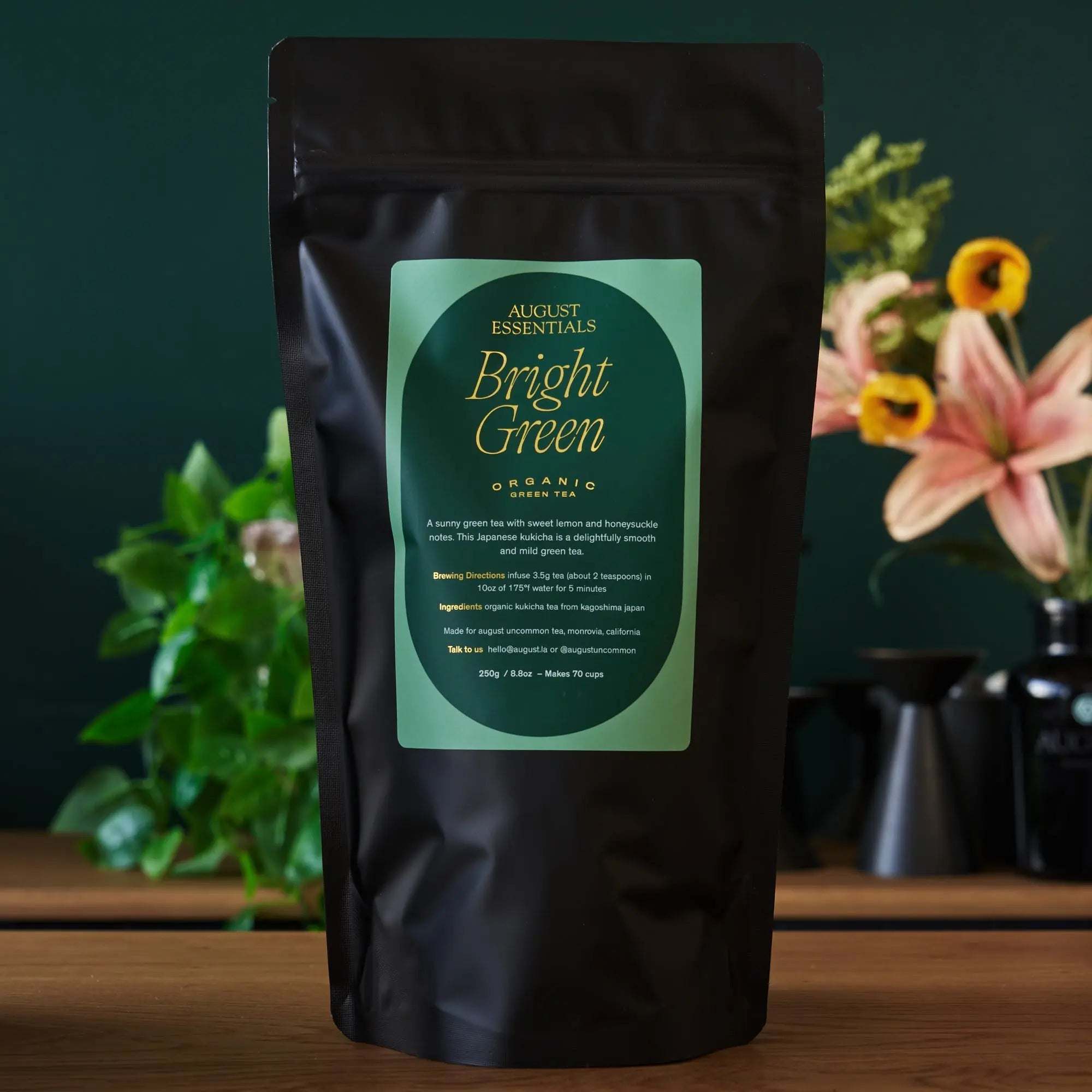 Essentials Bright Green Tea in a matte black pouch with a mint green label and gold lettering