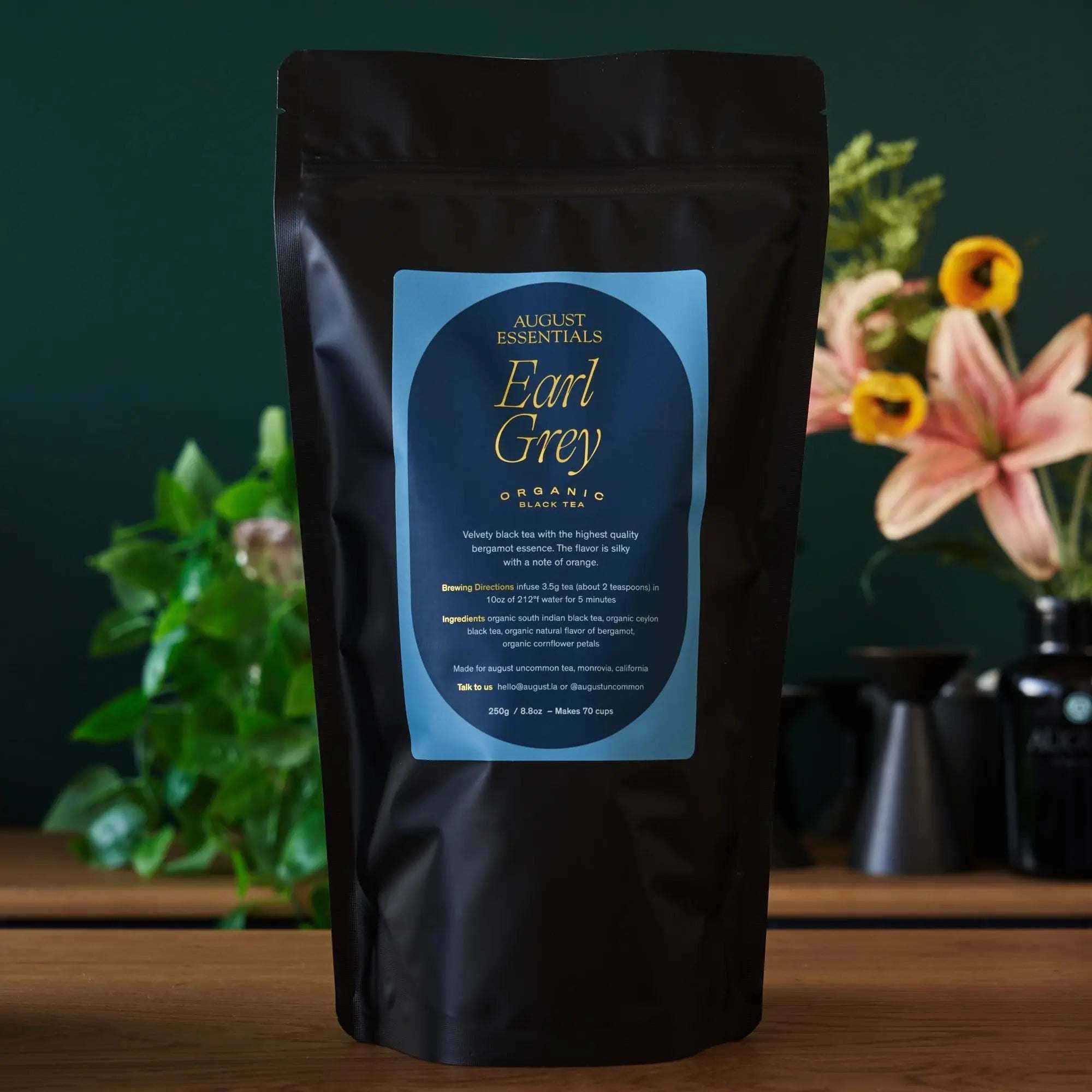 Essentials Earl Grey Black Tea in a matte black pouch with a blue label and gold lettering