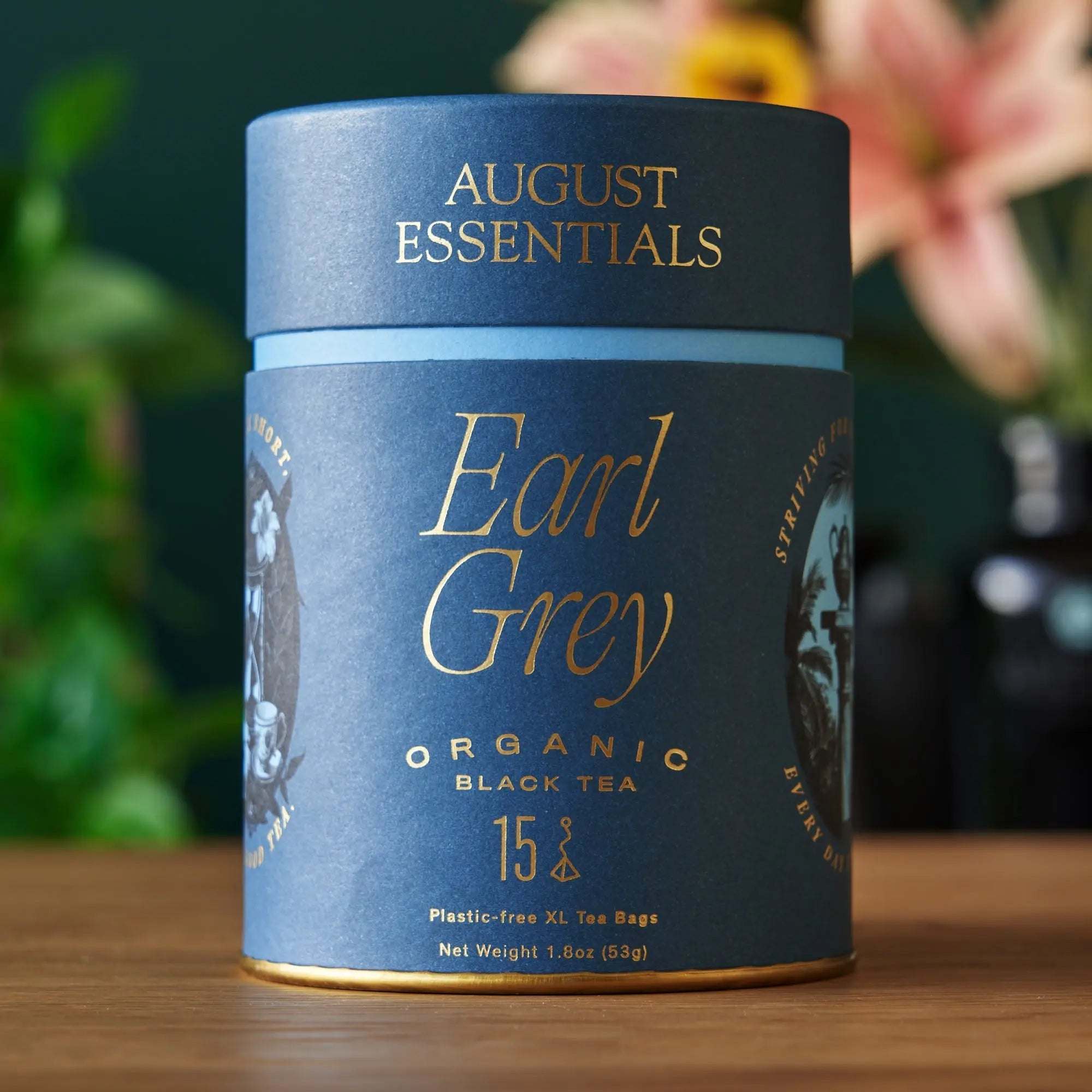 Essentials Earl Grey Black Tea in a blue cylindrical paper canister with gold lettering and Earl Grey label