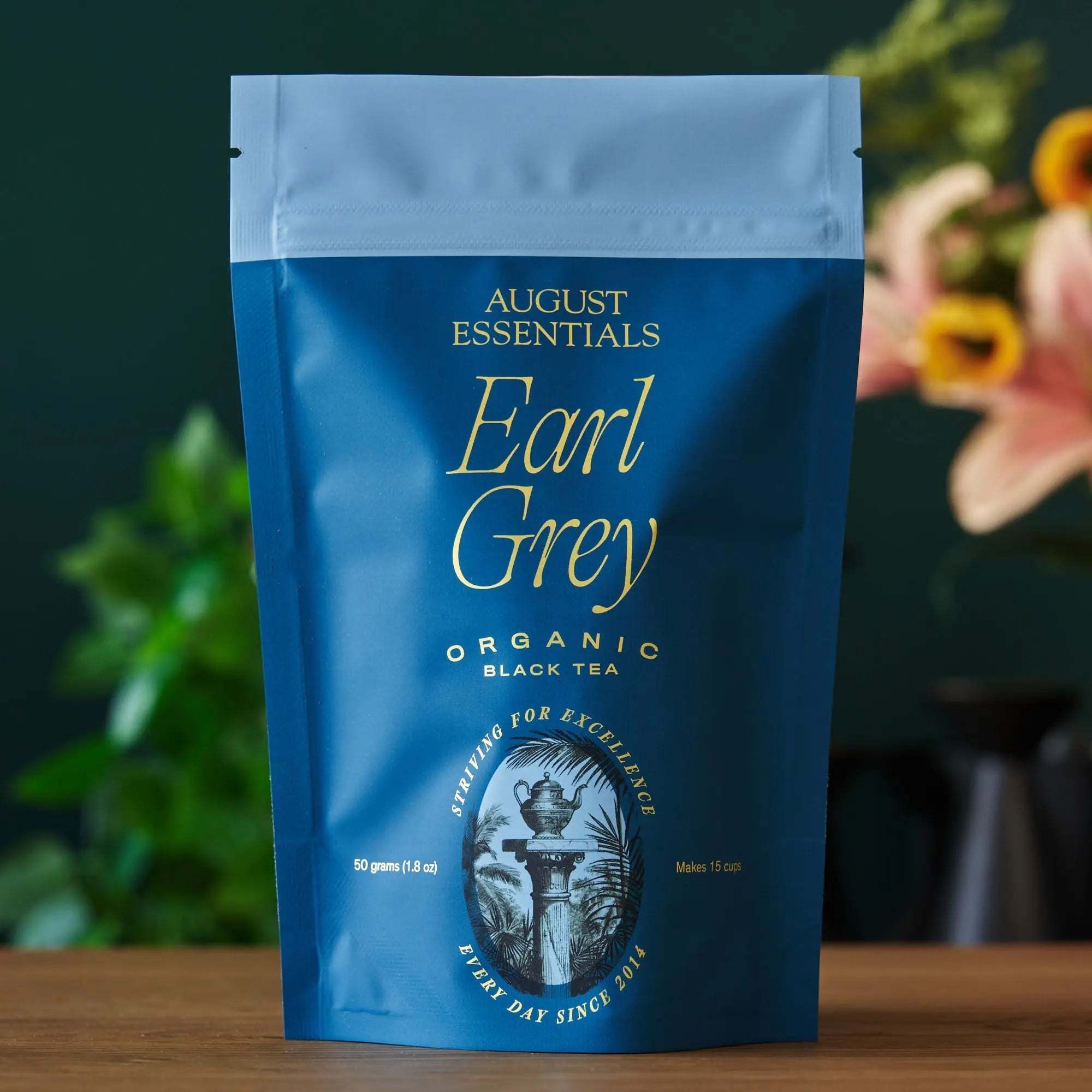 Essentials Earl Grey Black Tea in a blue matte pouch, featuring gold lettering and an organic black tea label