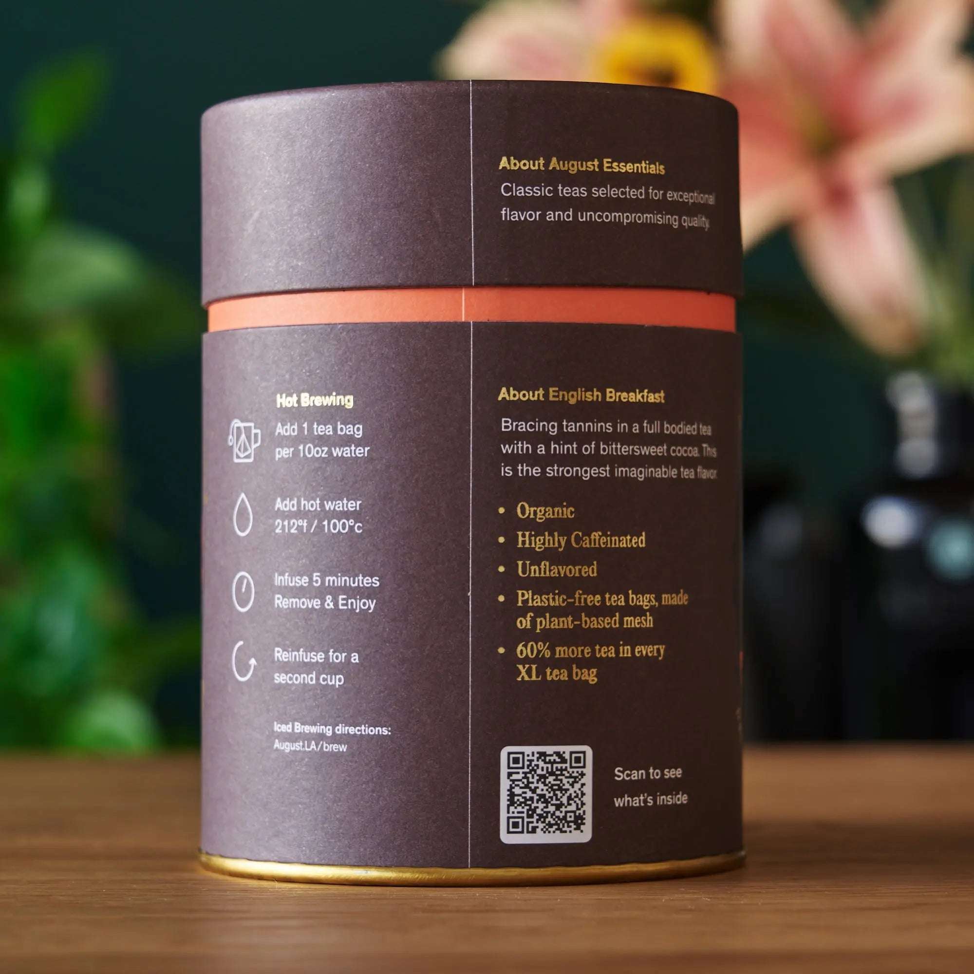 Essentials English Breakfast Black Tea cylindrical dark brown and mauve package with orange band and brewing instructions