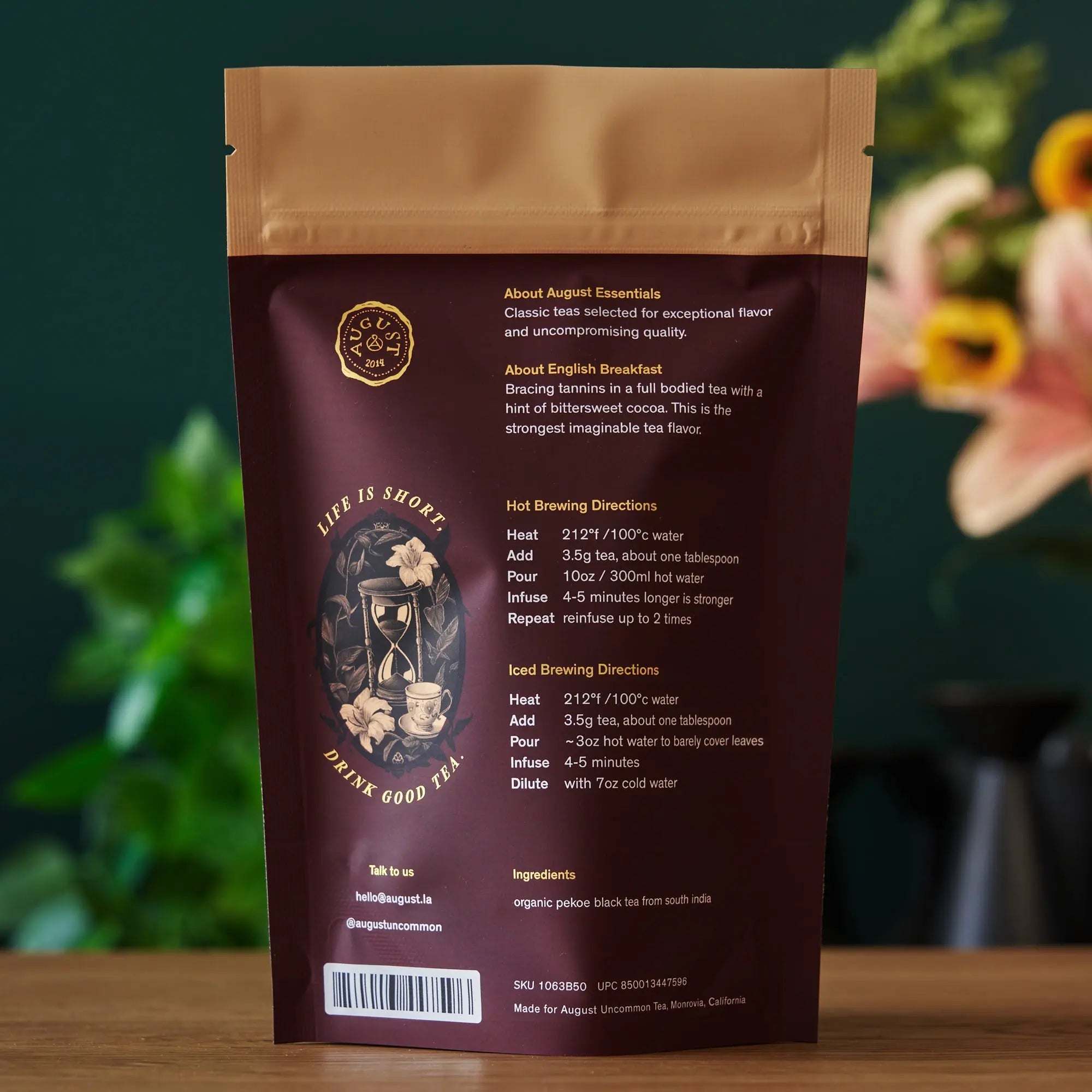 Essentials English Breakfast Black Tea in a burgundy resealable pouch, featuring gold text and vintage tea artwork