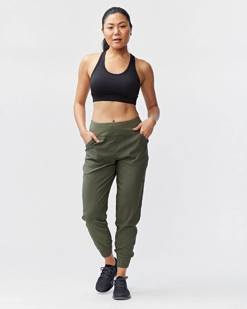 Excel Jogger in olive green woven fabric, featuring a relaxed tapered leg, elastic cuffs, and side pockets