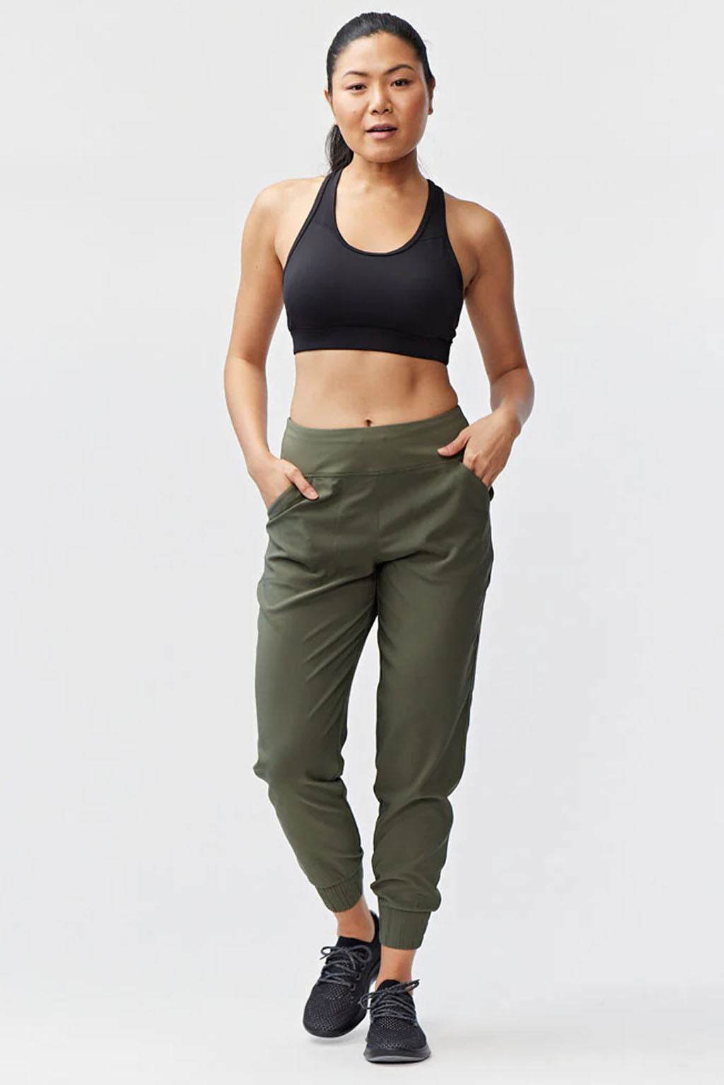 Excel Jogger olive green woven pants with a relaxed tapered fit, elastic cuffs, and side pockets