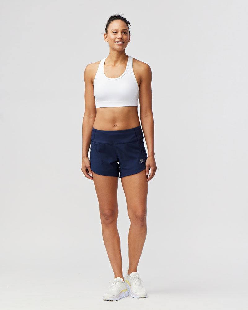 Excel Women's Workout Shorts in solid navy stretch fabric, featuring a wide waistband and relaxed mid-thigh fit
