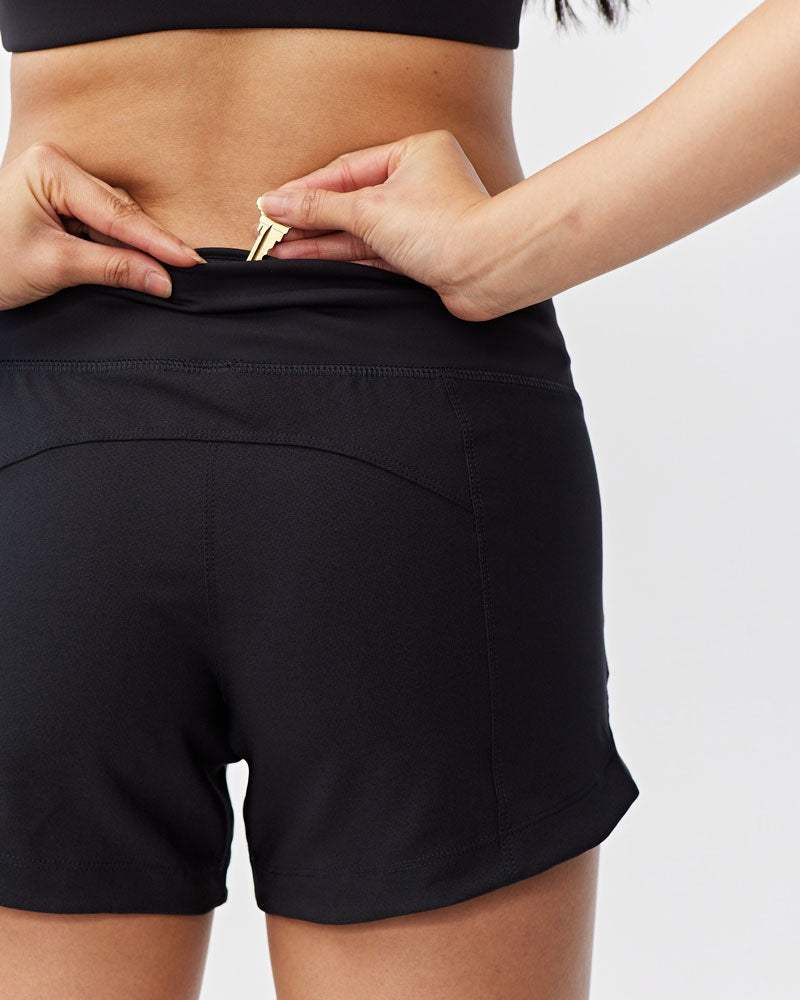 Excel Women's Workout Shorts in black stretch fabric, with a smooth waistband and hidden adjustable drawcord.