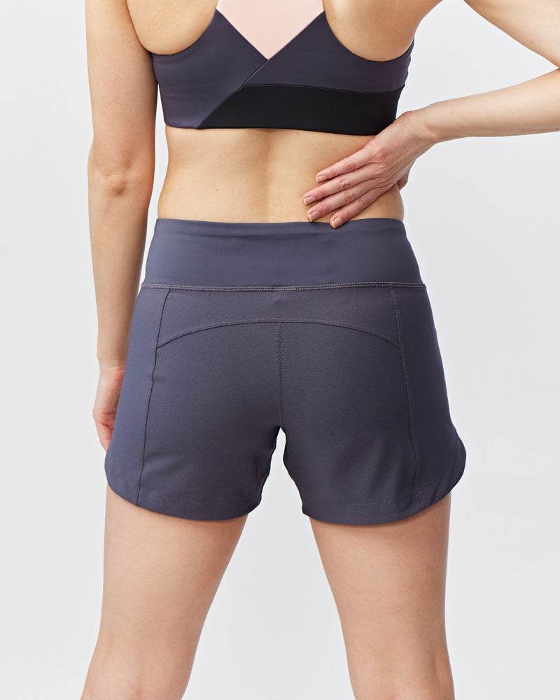 Excel Women's Workout Shorts in solid charcoal stretch fabric, featuring a wide waistband and curved back seam