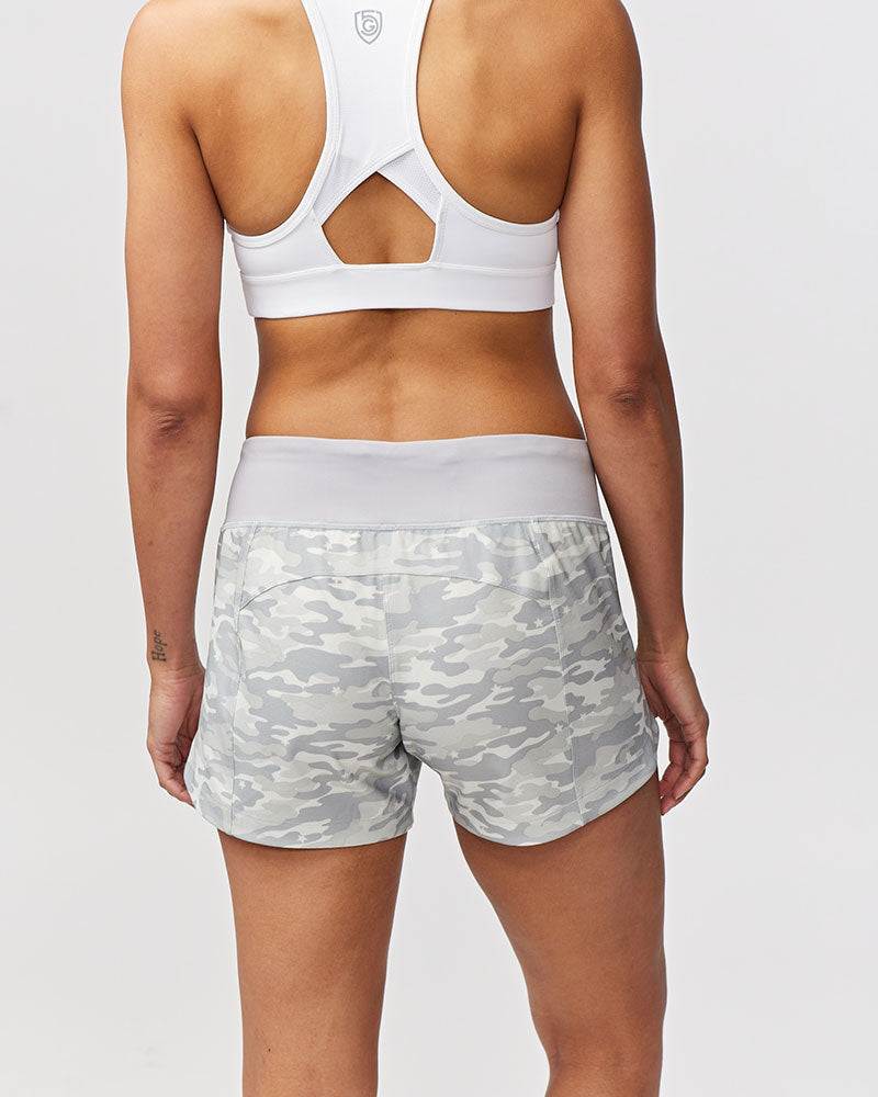 Excel Women's Workout Shorts in light gray camouflage print with a wide waistband and relaxed, curved hems