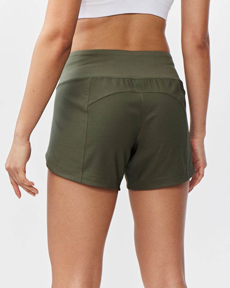 Excel Women's Workout Shorts in olive green stretch fabric, featuring a wide waistband and curved back seam