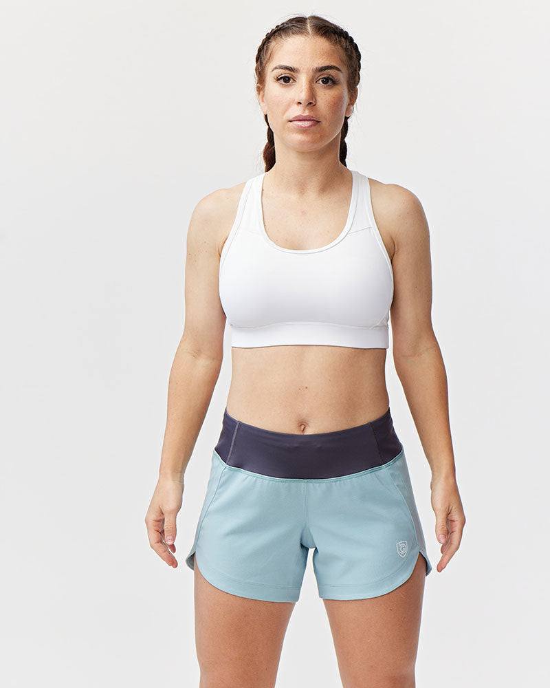 Excel Women's Workout Shorts in pale blue lightweight fabric, with a dark contrasting waistband and curved hems