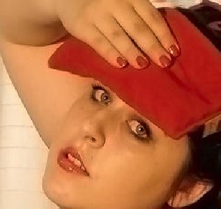 Eye Pillow in Red Denim made of soft red denim fabric held on a person's forehead for sinus relief and relaxation