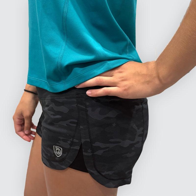 Fast & Free Women's Workout Shorts in black stretch fabric with a tonal camouflage pattern and curved overlapping hems
