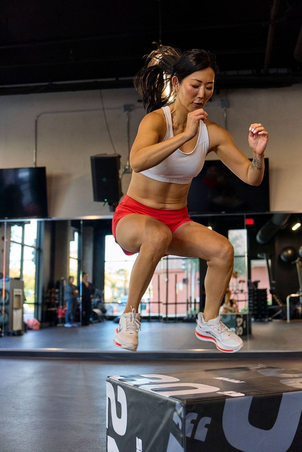 Fast & Free Women's Workout Shorts in bright red with a smooth stretch fabric and fitted cut, worn for box jumps