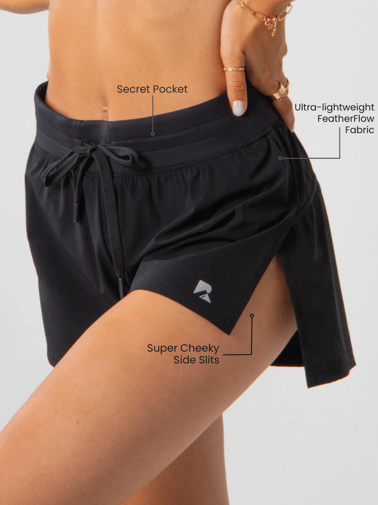 Flyaway Short in black lightweight fabric with a drawstring waistband, hidden pocket and cheeky side slits