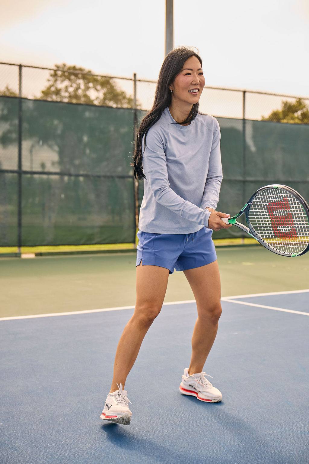 Foudy 2.0 Women's long sleeve athletic top in pale lavender, with a crew neck and fitted cuffs, worn with blue shorts