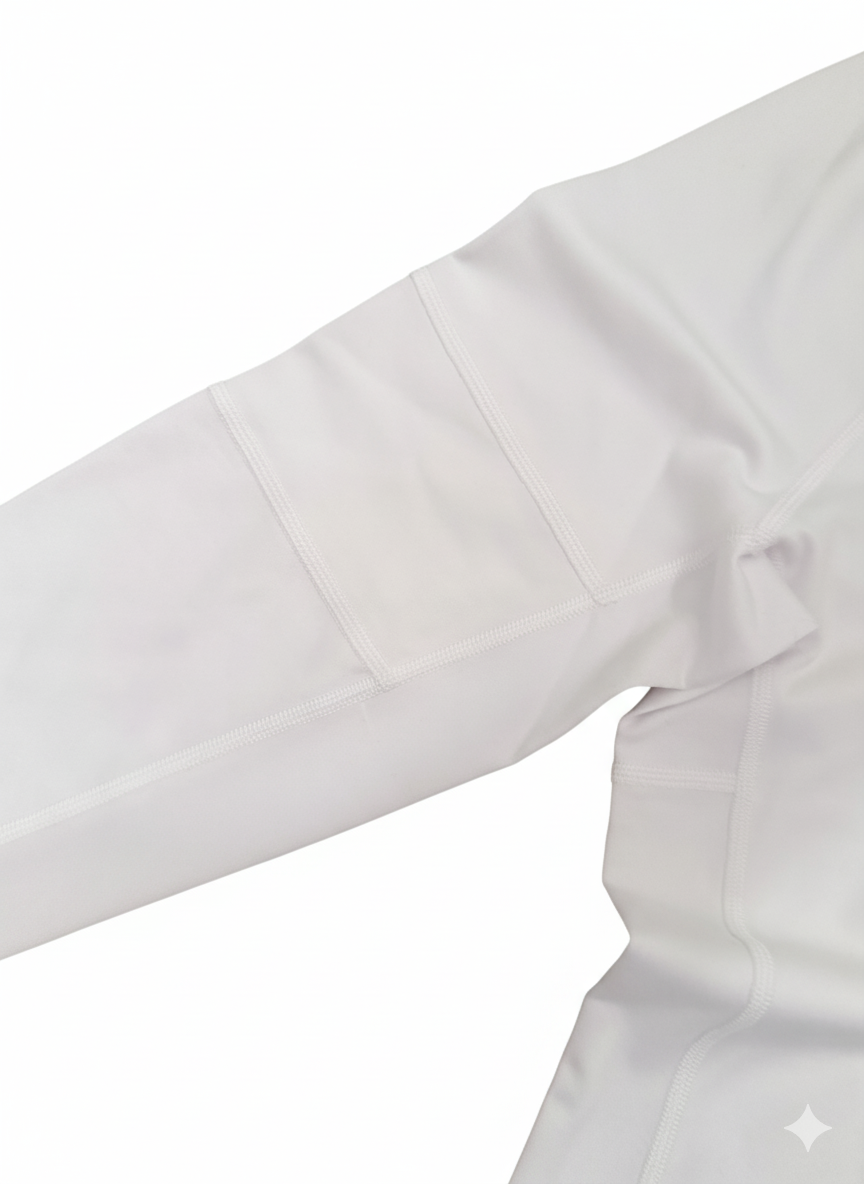 Foudy Mid-Weight Long Sleeve top in pale grey performance fabric, showing a subtle stitched captain's armband detail on the upper sleeve
