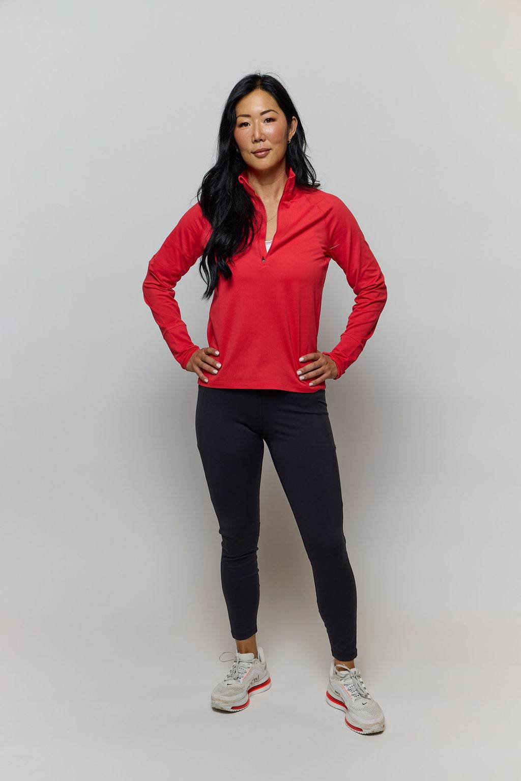 Foudy Mid-Weight Long Sleeve red mid-weight top with long sleeves, a short zip neckline and a subtle arm detail