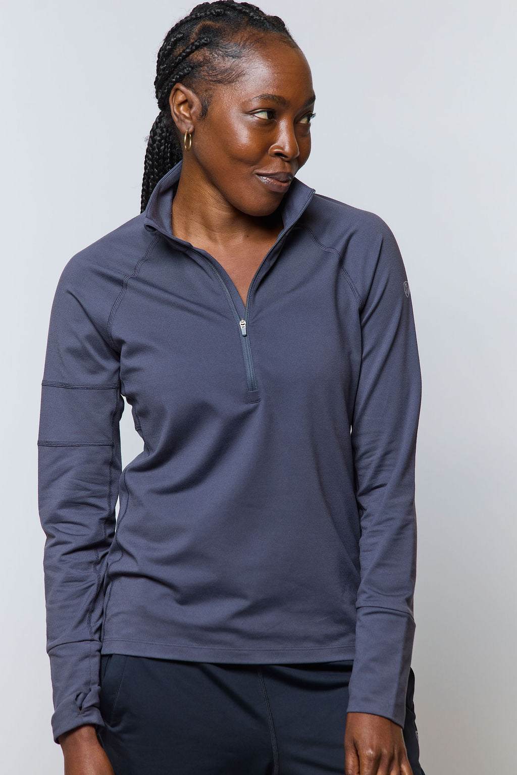 Foudy Mid-Weight Long Sleeve top in slate blue, with a soft solid fabric, stand collar and short front zip