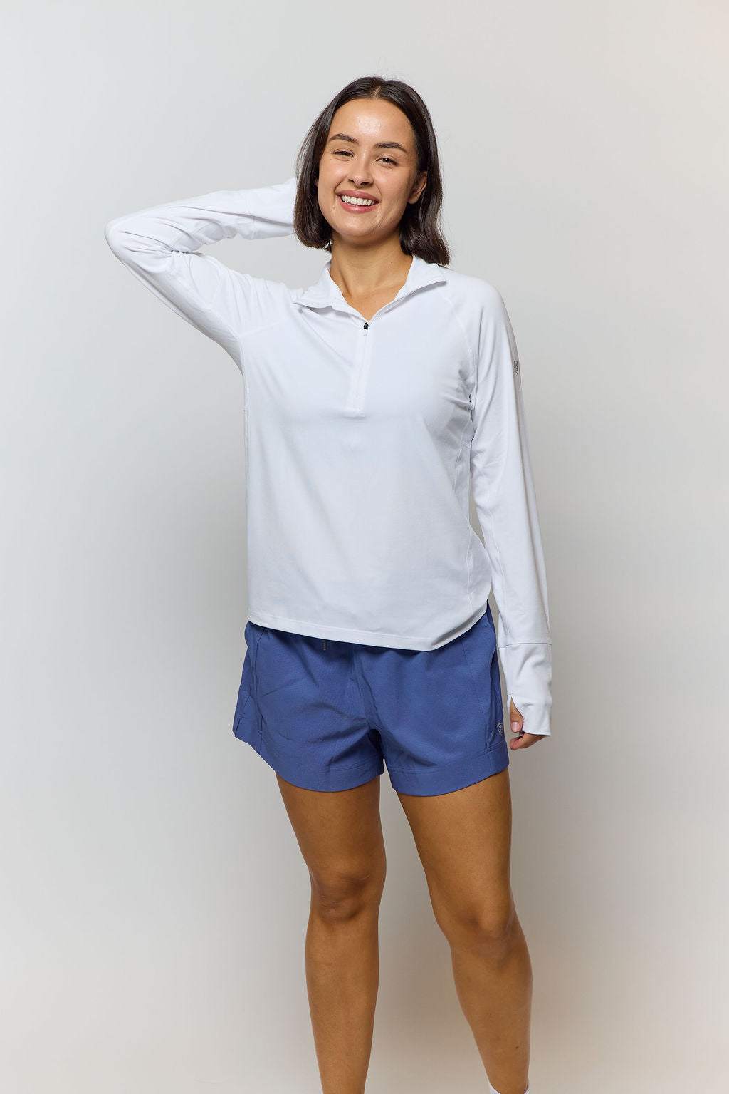 Foudy Mid-Weight Long Sleeve white performance top with long sleeves, short quarter zip collar, and subtle arm detail