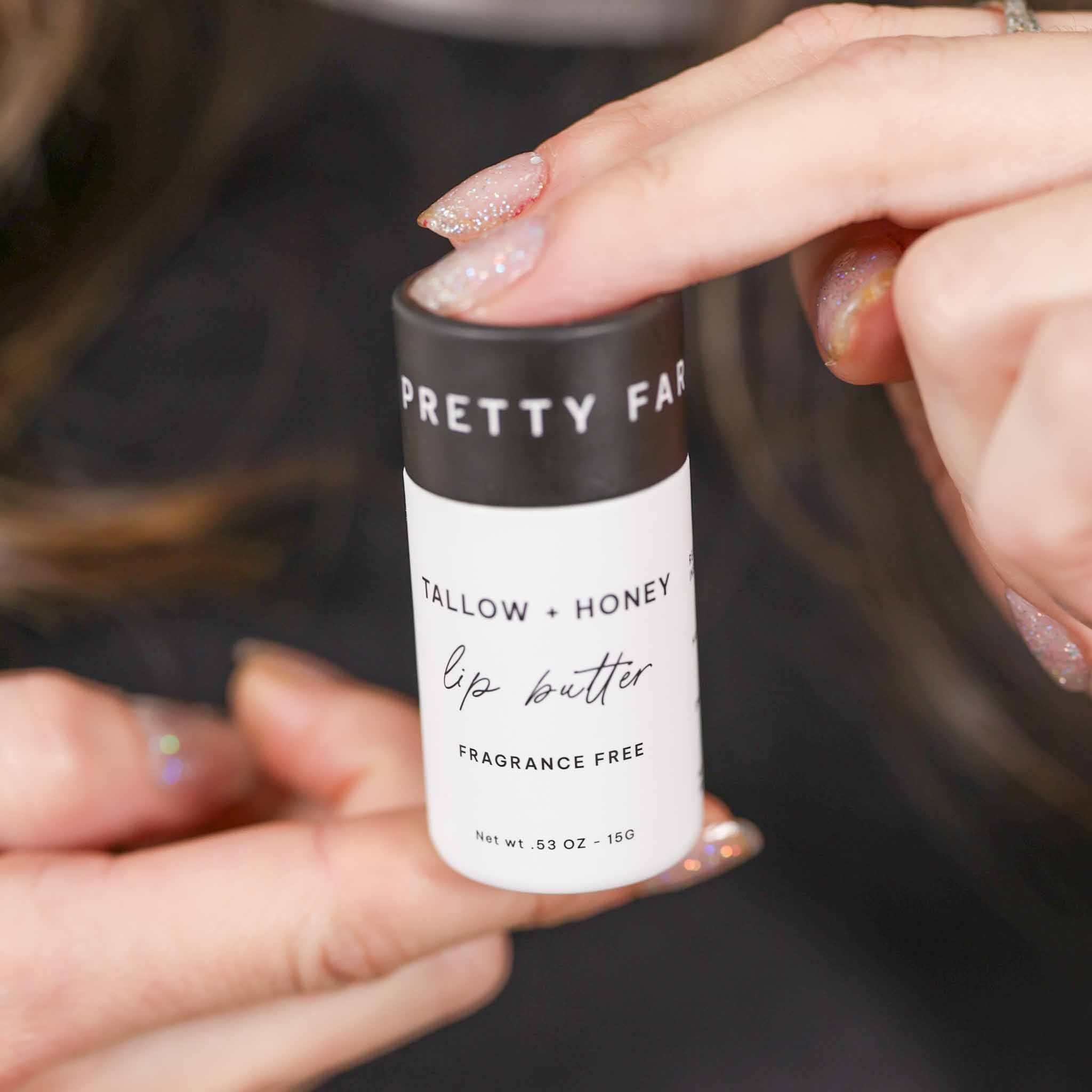 Fragrance Free Tallow + Honey lip butter in a white paper travel tube with black label and handwritten-style text
