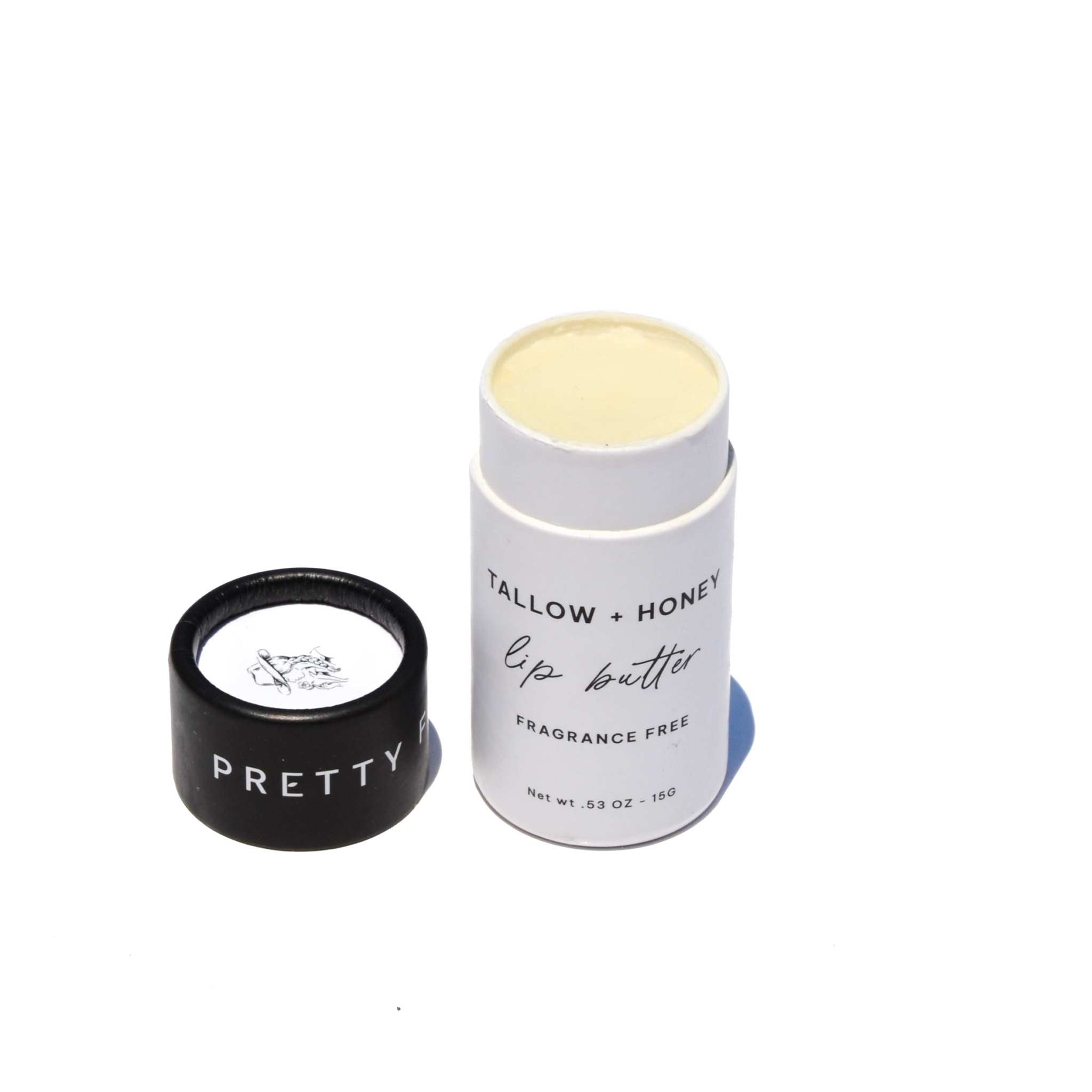 Fragrance Free Tallow + Honey lip butter in a white paper travel tube with creamy balm and black cap