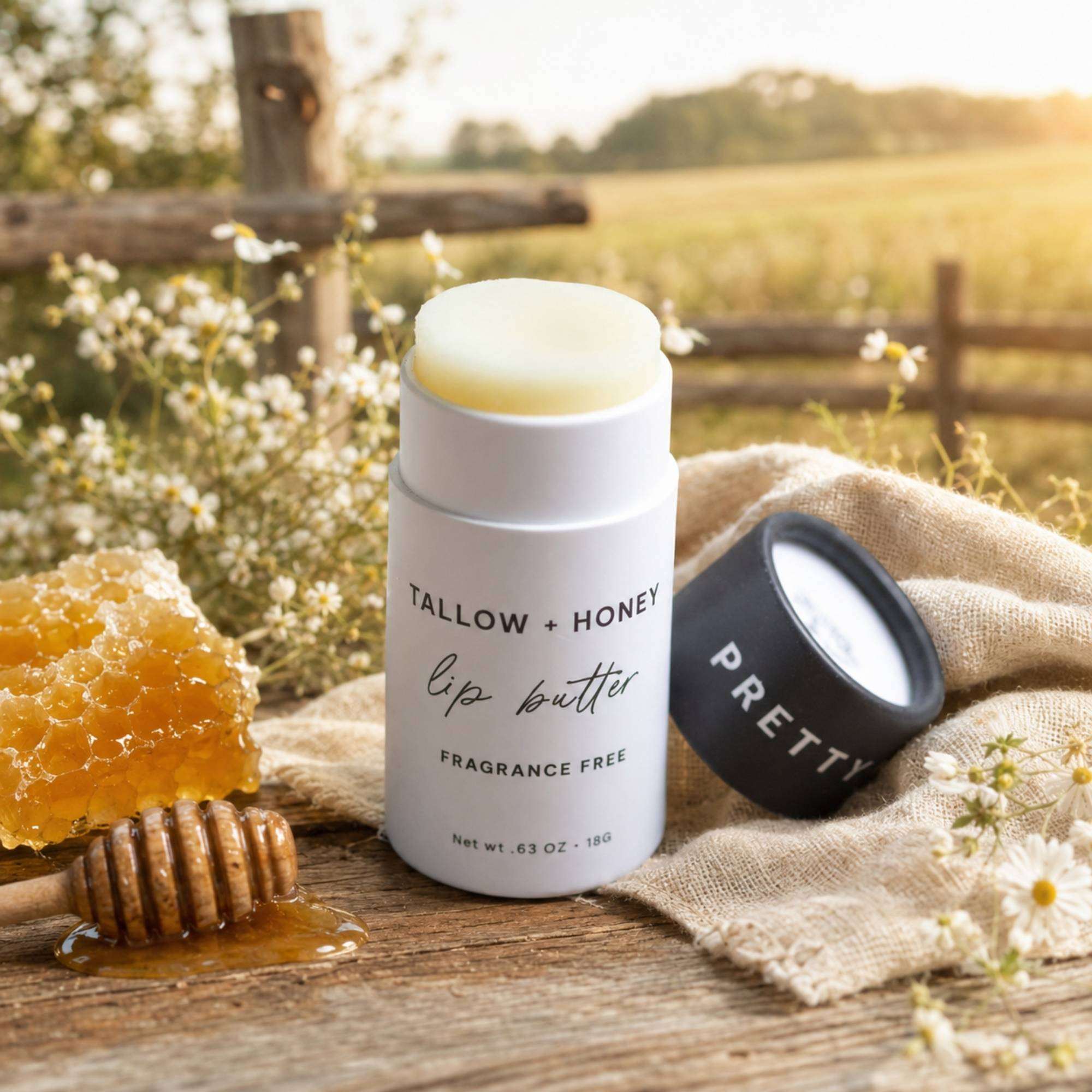 Fragrance Free Tallow + Honey lip butter in a white paper travel tube with creamy balm and black cap