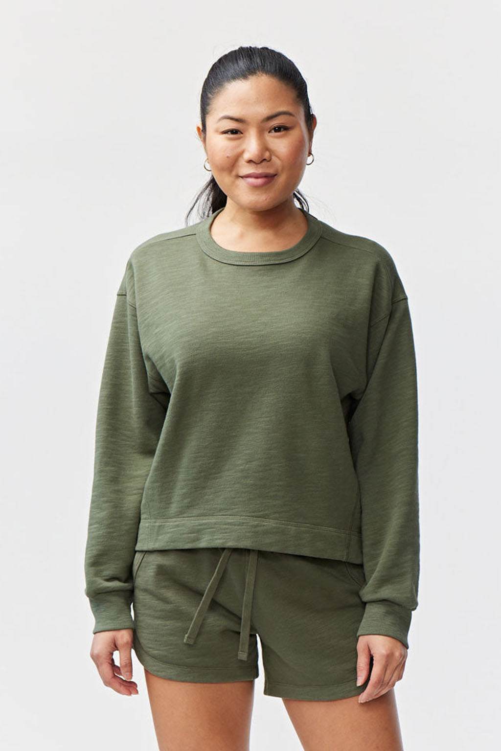Freasy Crew sweatshirt in muted olive green with a crew neckline, long sleeves, and a relaxed, slightly cropped fit