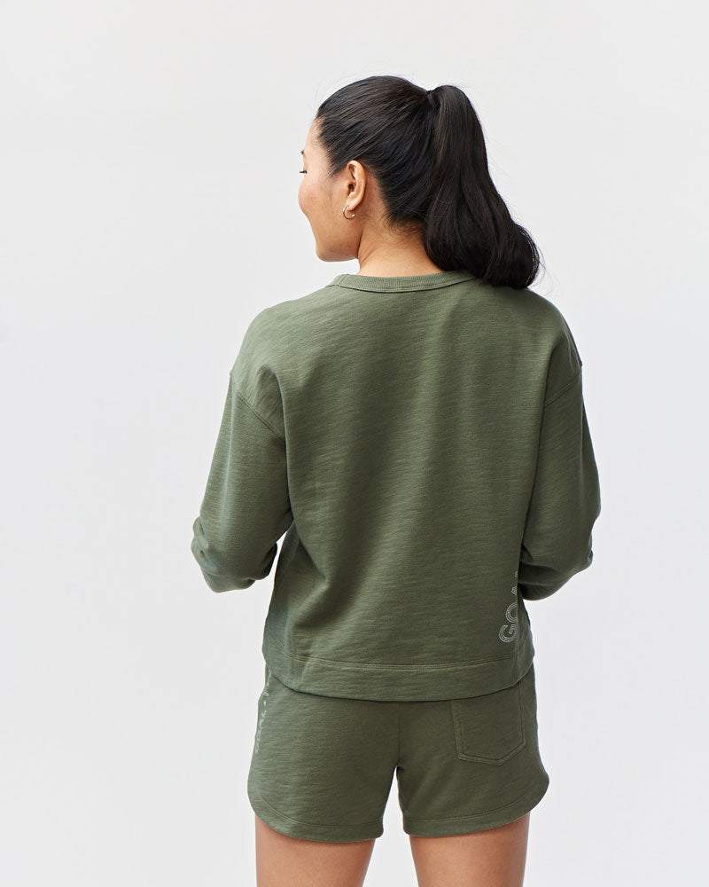 Freasy Crew sweatshirt in muted olive green, with a soft-looking fabric, relaxed fit and classic crew neckline