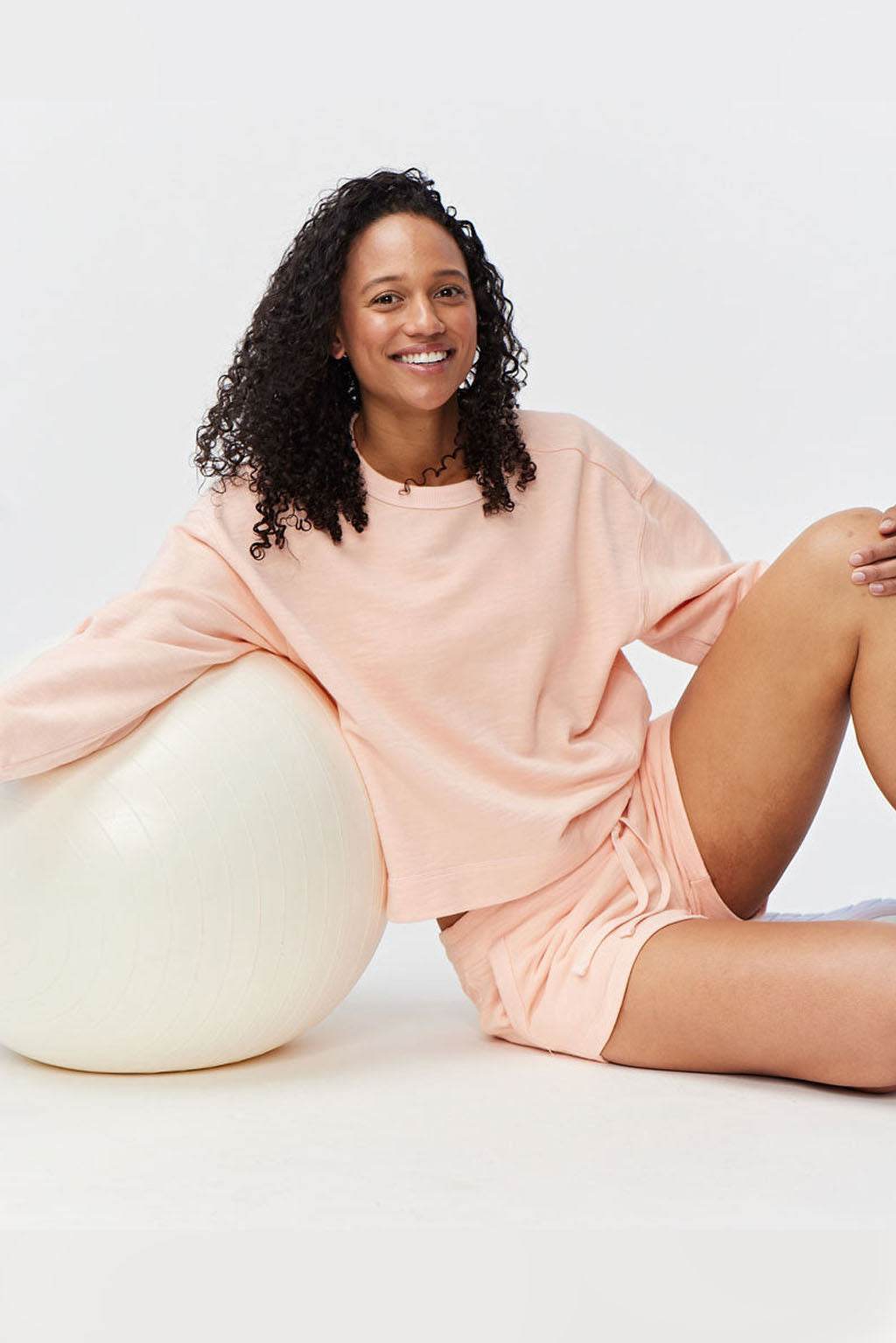 Freasy Crew sweatshirt in pale peach, with a soft solid-color finish, relaxed oversized fit, and crew neckline