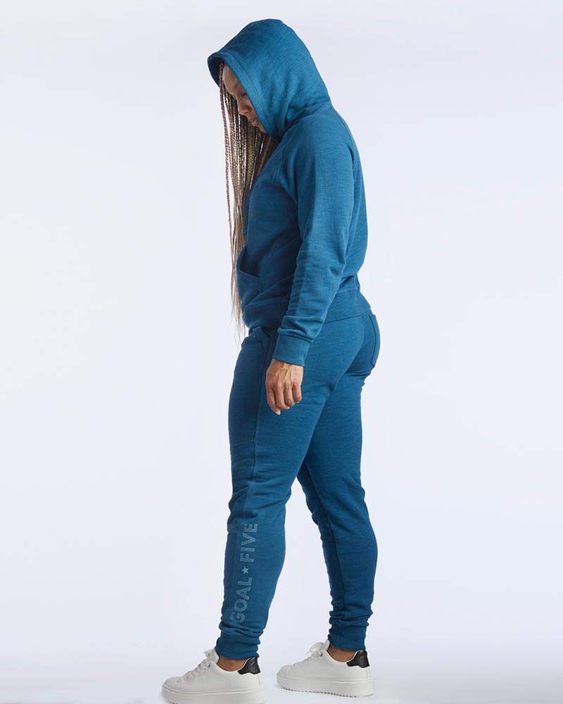 Freasy Jogger in teal lightweight fabric with tapered legs, ribbed ankle cuffs and a subtle vertical logo